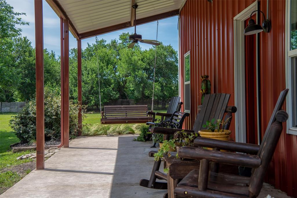 8665 Cr-669 Blue Ridge Blue Ridge, TX 75424 - Photo 3 of 40 a view of a chair and tables in the patio in front of a house