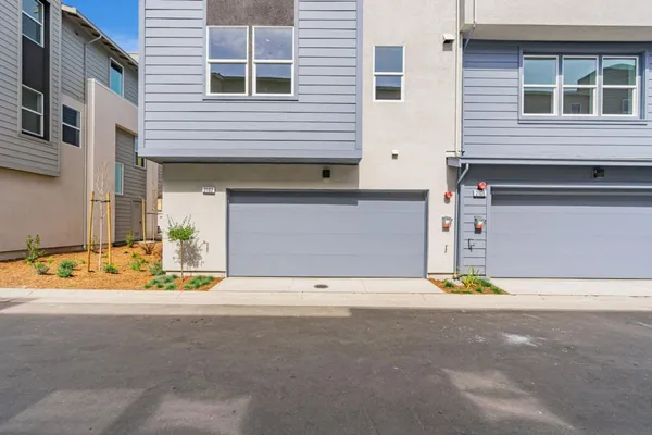 a front view of a house with a yard and a garage