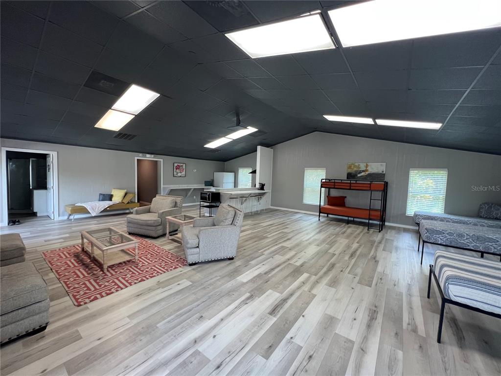 8806 Southwest Start Center Street Arcadia, FL 34269 - Photo 11 of 21 a living room with furniture and a wooden floor