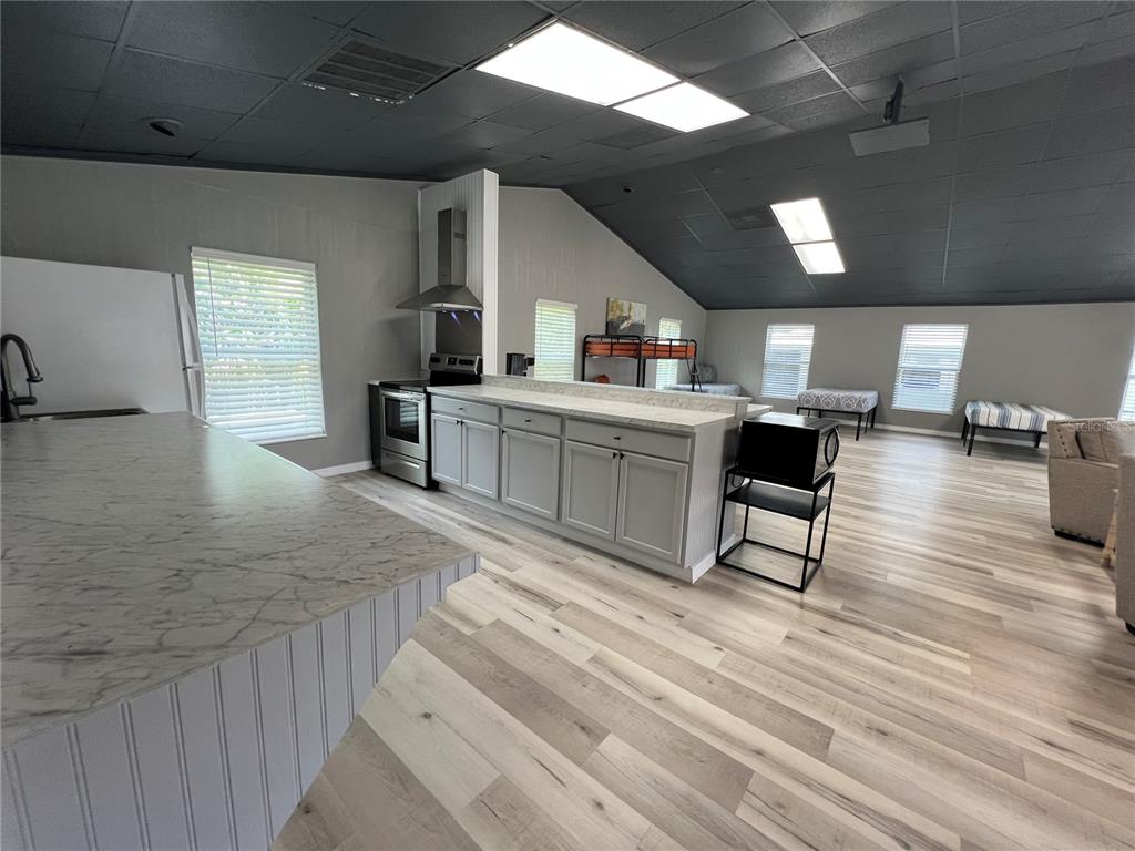 8806 Southwest Start Center Street Arcadia, FL 34269 - Photo 12 of 21 a view of a kitchen with dining room and wooden floor