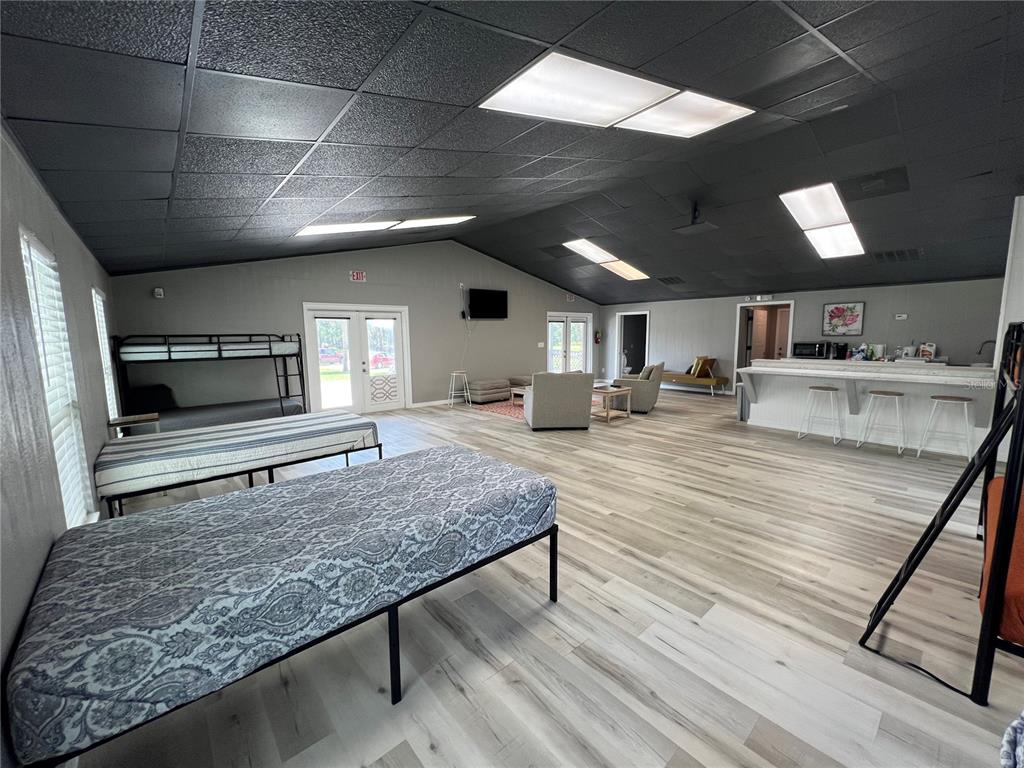 8806 Southwest Start Center Street Arcadia, FL 34269 - Photo 15 of 21 a living room with kitchen appliances and a wooden floor