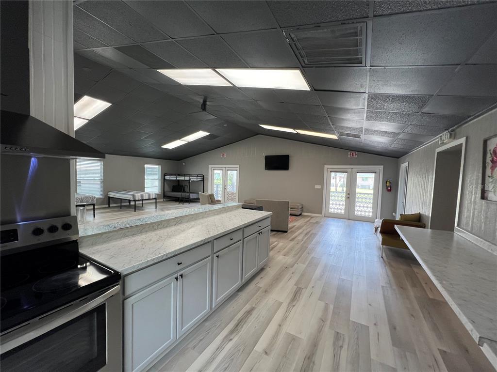 8806 Southwest Start Center Street Arcadia, FL 34269 - Photo 6 of 21 a kitchen with a stove and a wooden floor