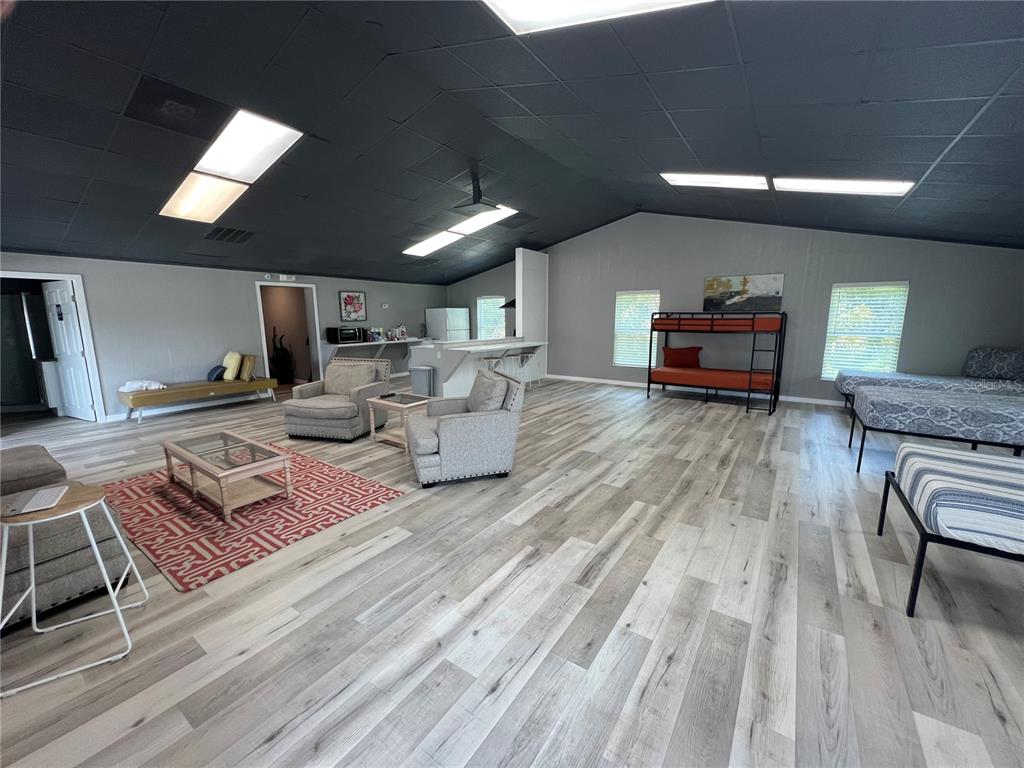 8806 Southwest Start Center Street Arcadia, FL 34269 - Photo 7 of 21 a living room with furniture and a wooden floor
