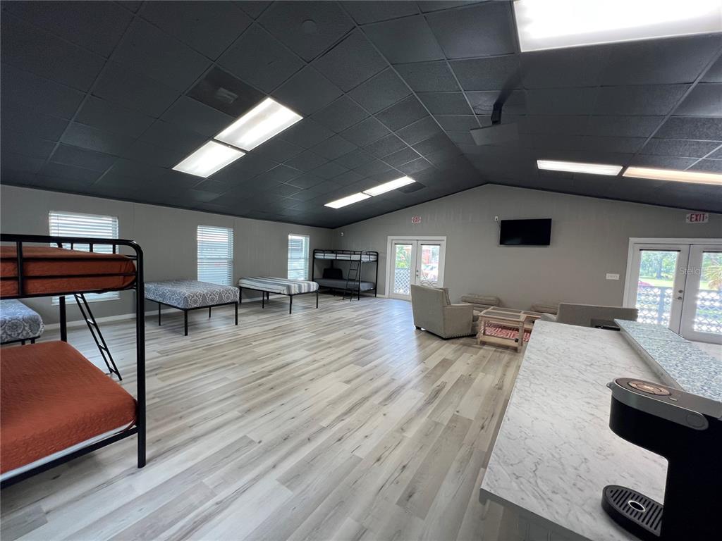 8806 Southwest Start Center Street Arcadia, FL 34269 - Photo 9 of 21 a living room with furniture and a wooden floor