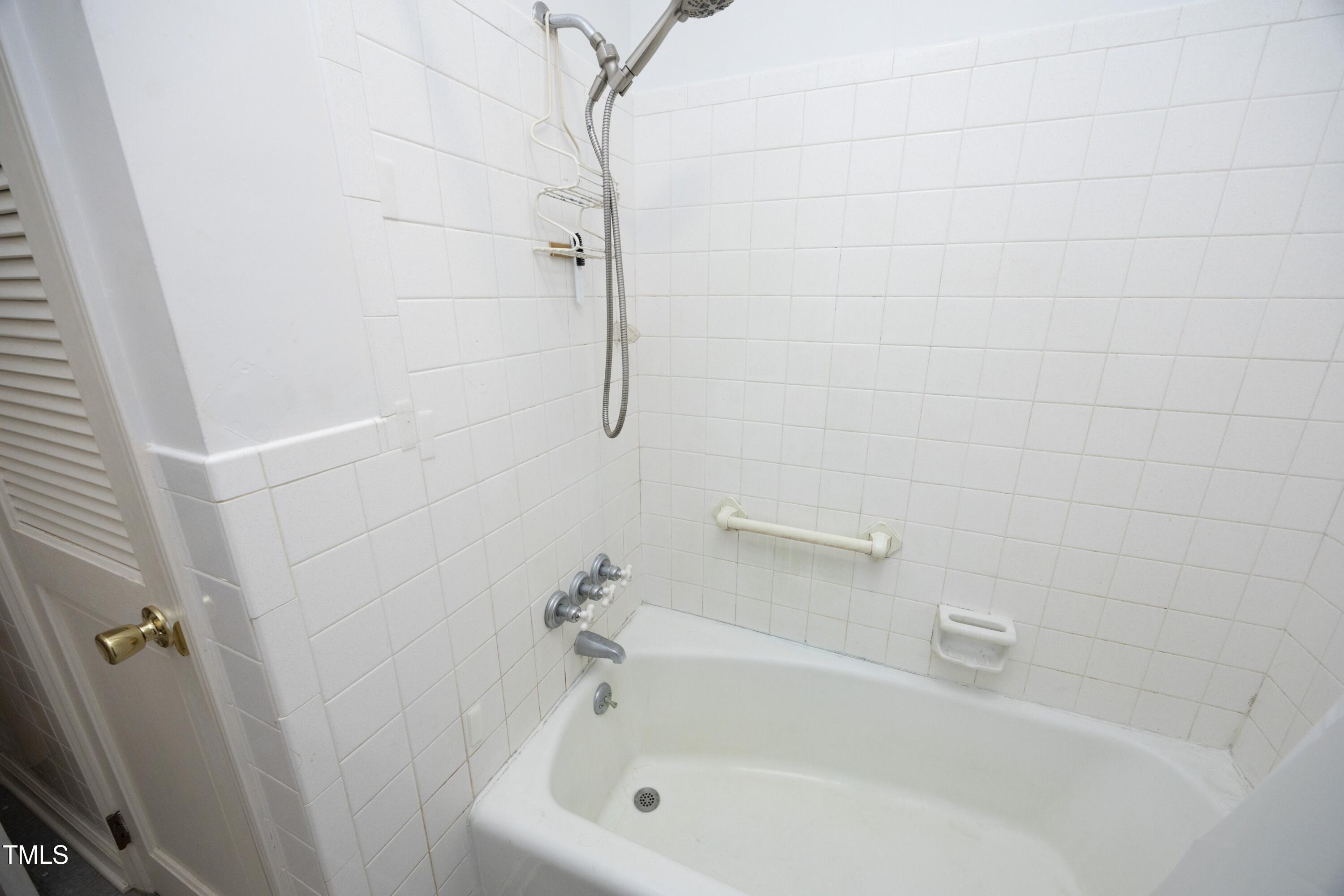615 Locust Lane Raleigh, NC 27603 - Photo 19 of 28 a bathroom with a bathtub
