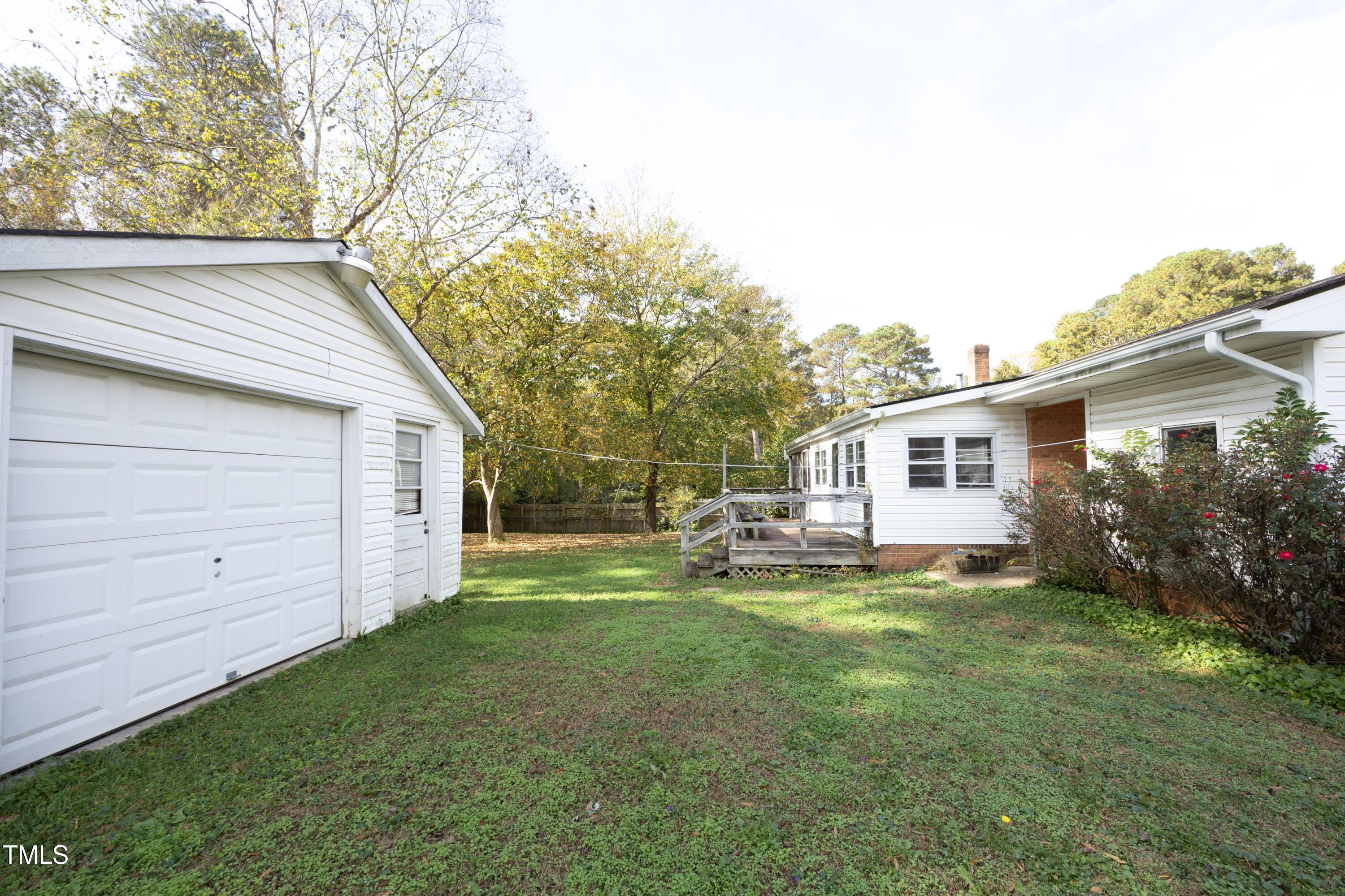 615 Locust Lane Raleigh, NC 27603 - Photo 23 of 28 a backyard of a house with table and chairs