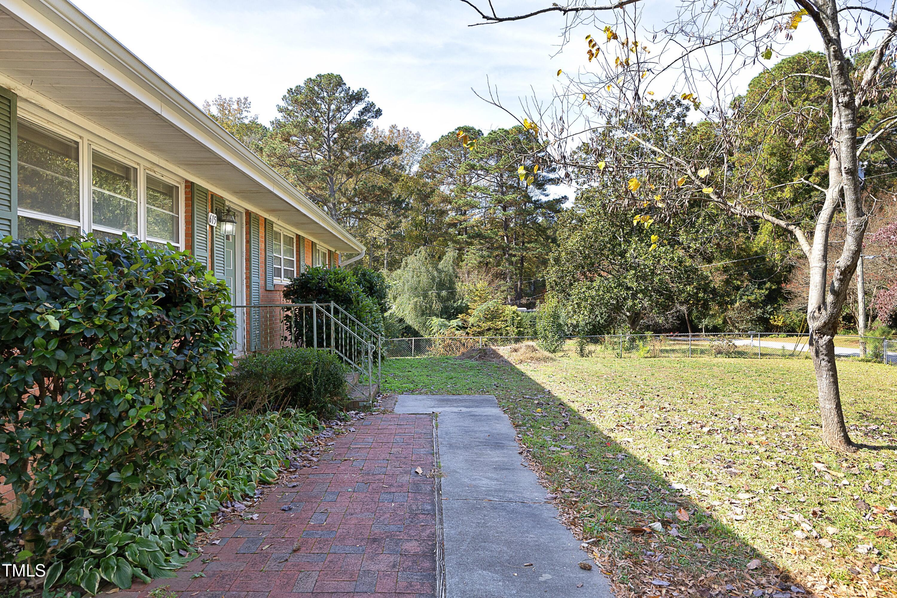 615 Locust Lane Raleigh, NC 27603 - Photo 3 of 28 a view of a pathway with a yard
