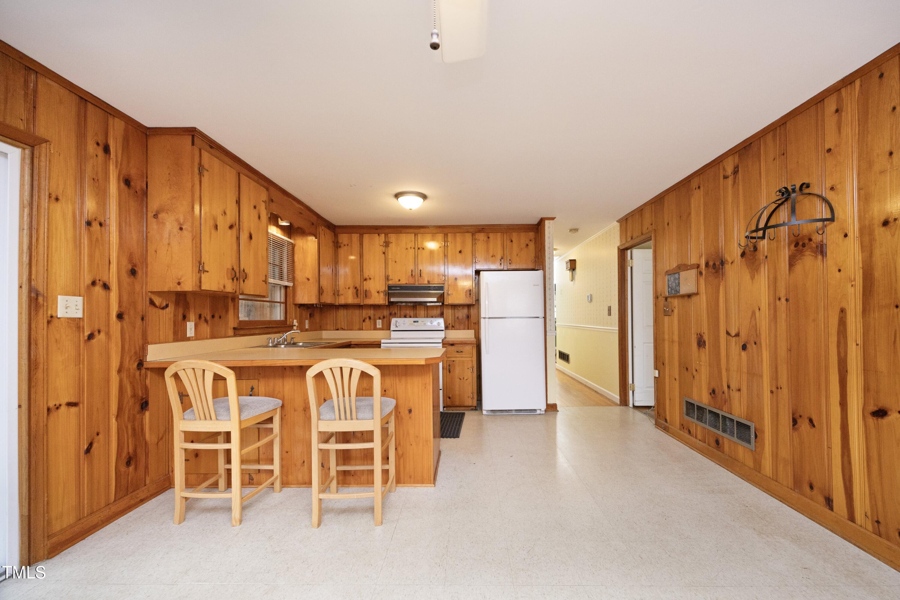 615 Locust Lane Raleigh, NC 27603 - Photo 8 of 28 a kitchen with a refrigerator and a table