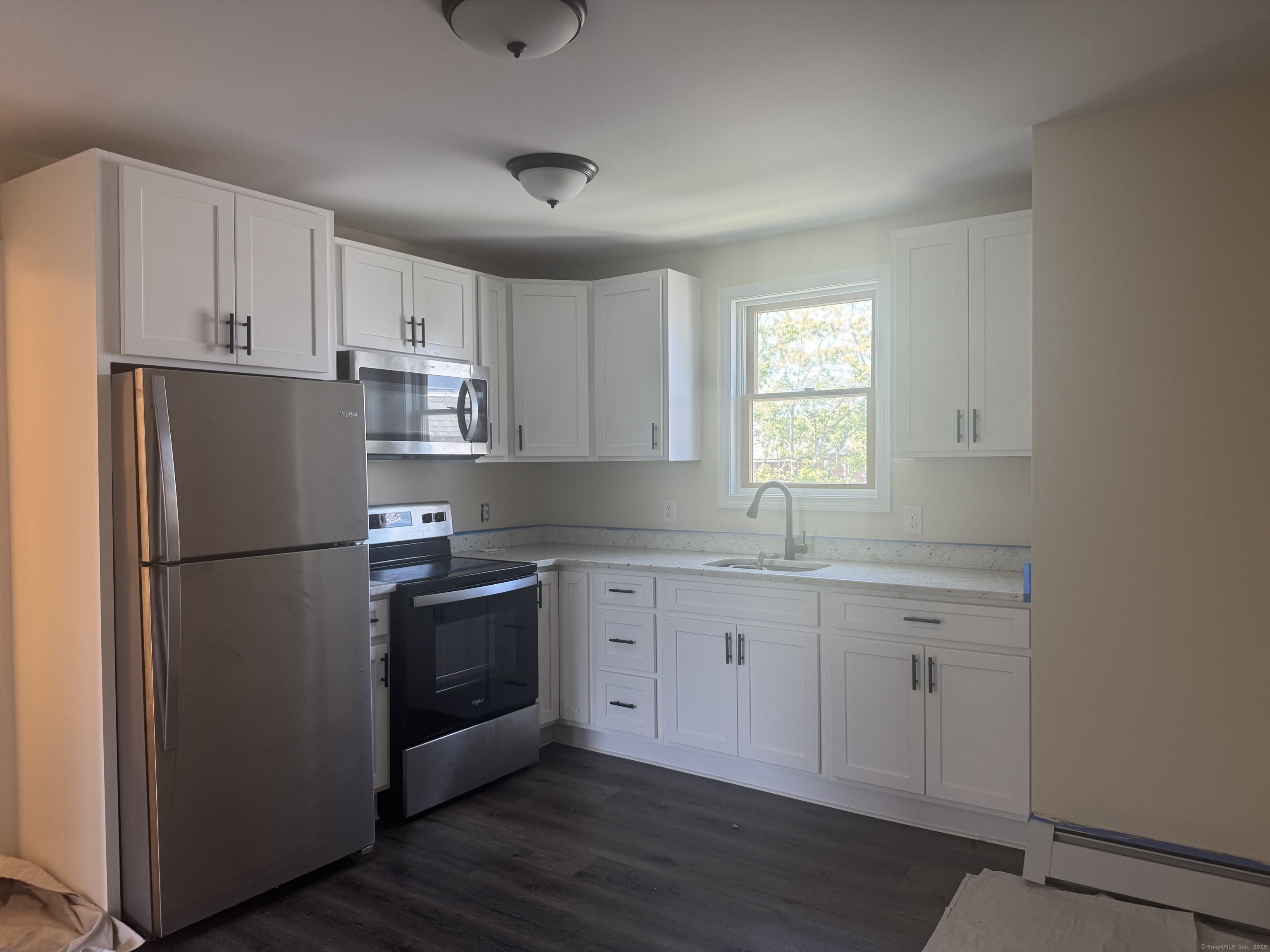 51 Russ Street, Unit 51D Hartford, CT 06106 - Photo 2 of 5 a kitchen with stainless steel appliances a refrigerator sink and cabinets