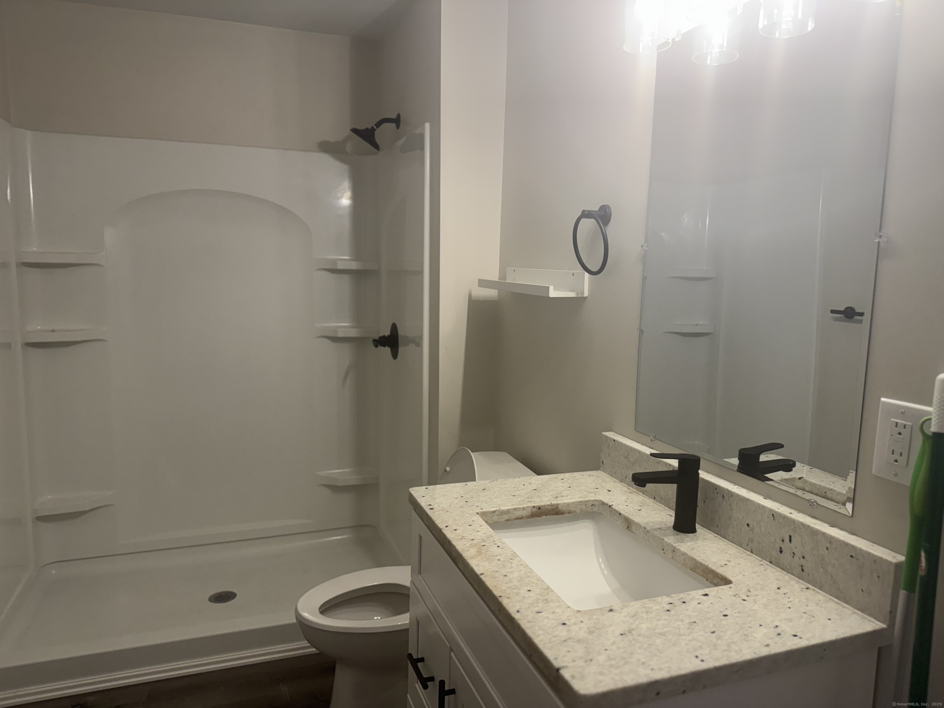 51 Russ Street, Unit 51D Hartford, CT 06106 - Photo 4 of 5 a bathroom with a granite countertop sink a toilet and shower