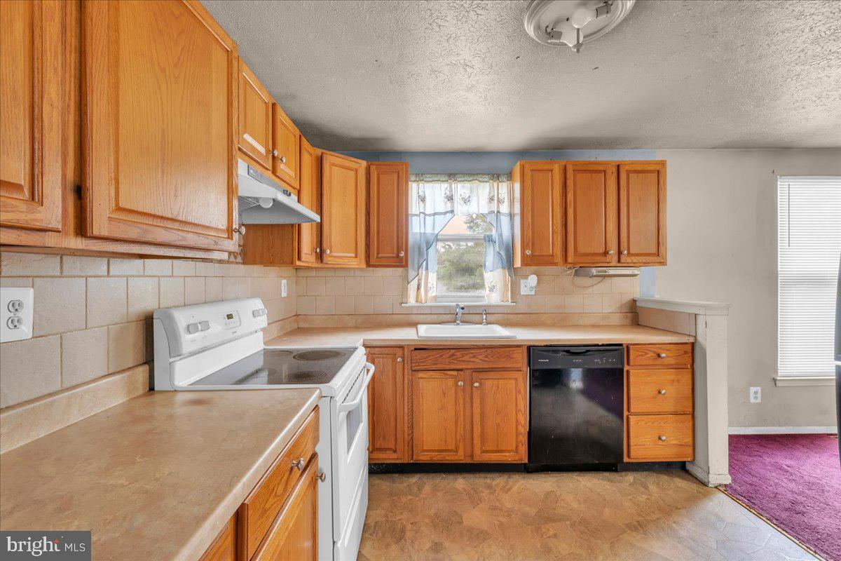 11 Decatur Lane Sicklerville, NJ 08081 - Photo 10 of 24 a kitchen with stainless steel appliances granite countertop a sink a stove and a refrigerator