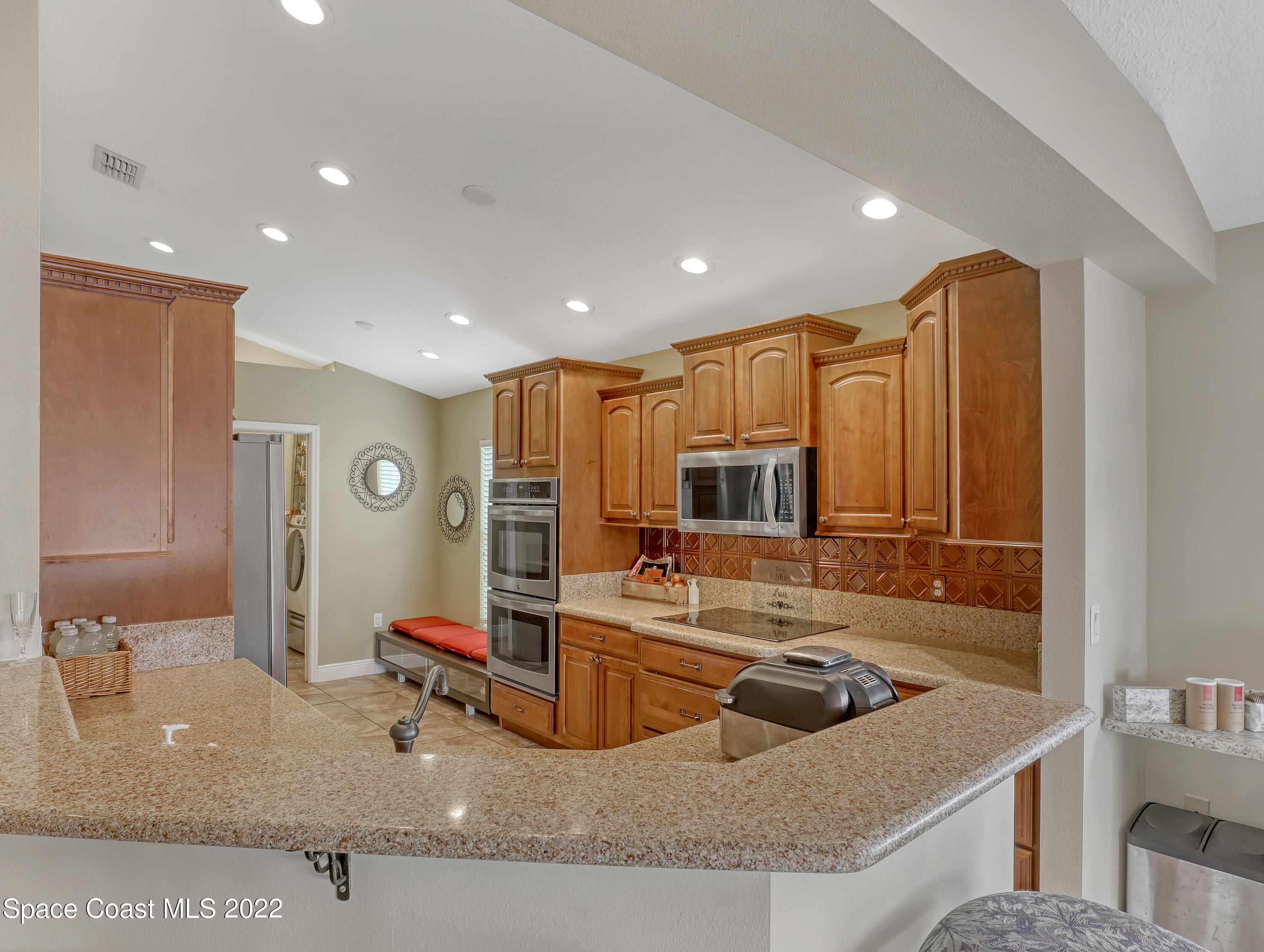 3935 Orion Way Rockledge, FL 32955 - Photo 11 of 30 a kitchen with stainless steel appliances granite countertop a sink a stove and a refrigerator
