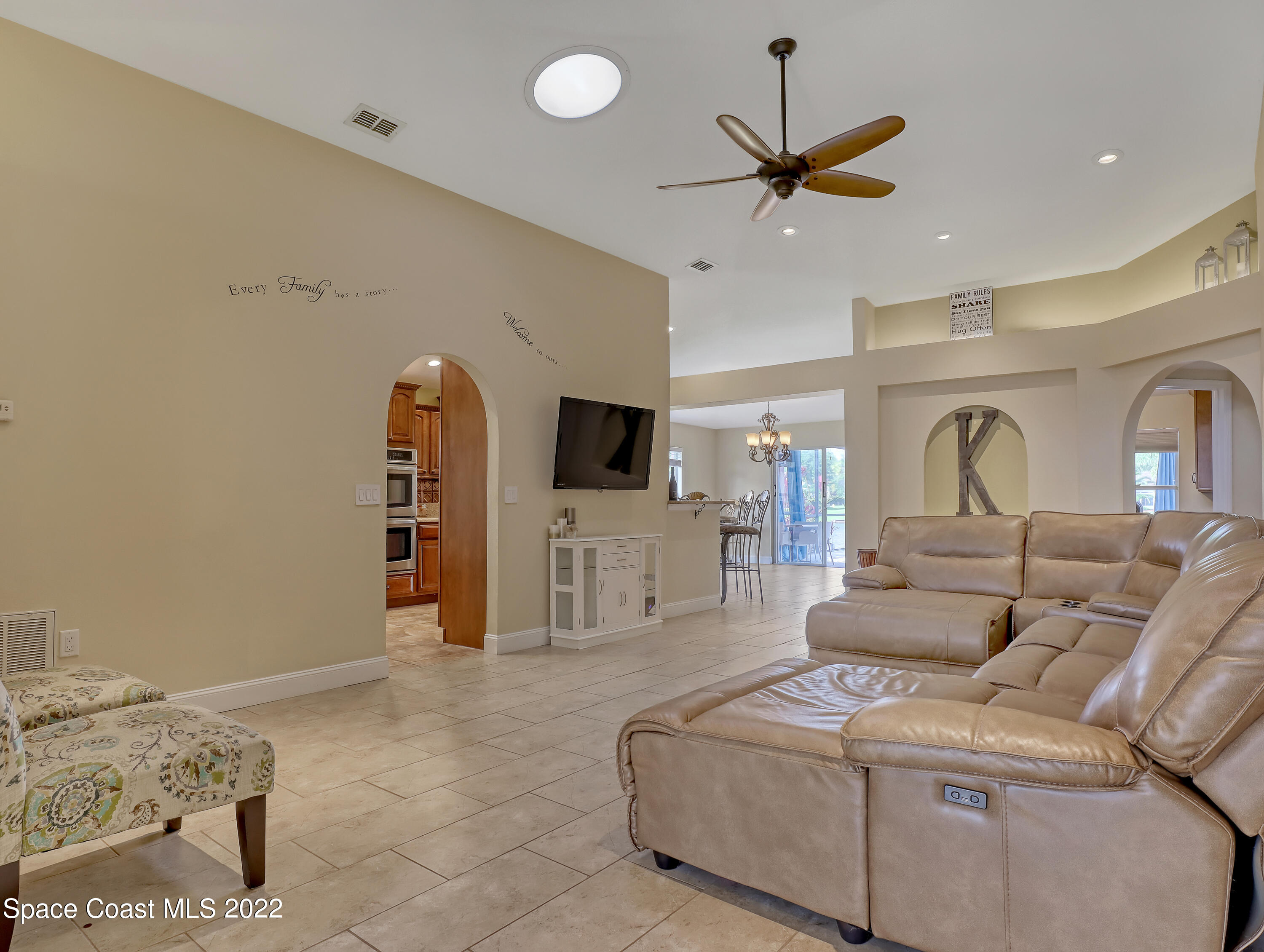 3935 Orion Way Rockledge, FL 32955 - Photo 15 of 30 a living room with furniture a ceiling fan and a rug