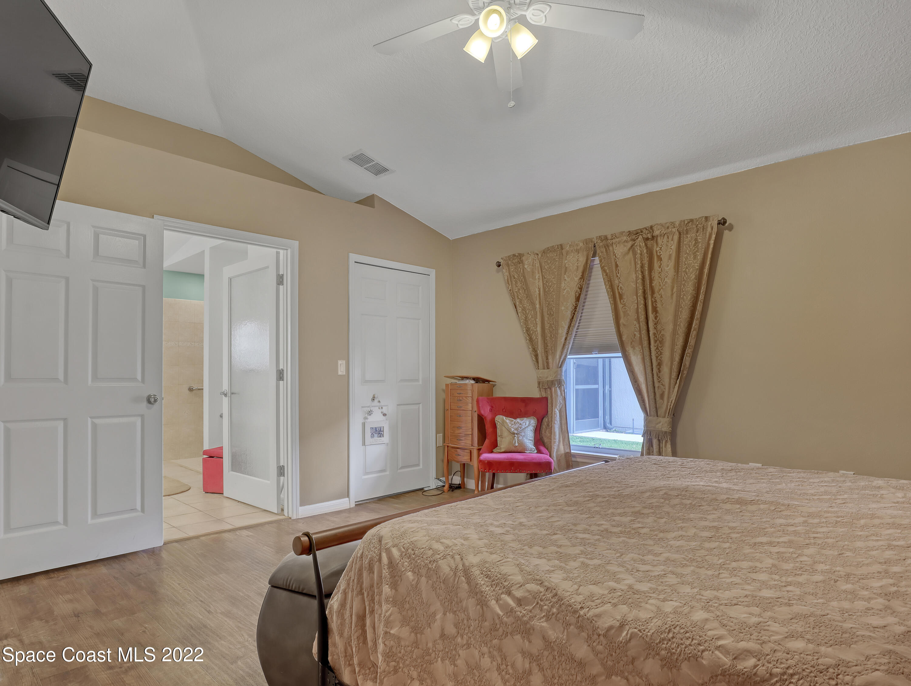 3935 Orion Way Rockledge, FL 32955 - Photo 17 of 30 a bedroom with a bed and a flat screen tv
