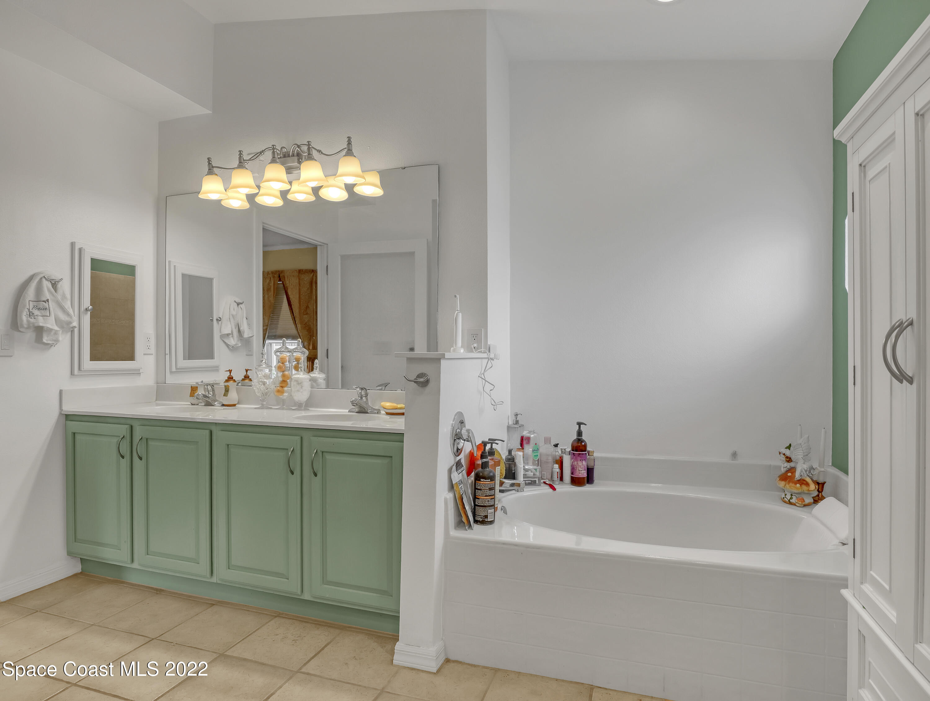 3935 Orion Way Rockledge, FL 32955 - Photo 19 of 30 a spacious bathroom with a tub sink and a mirror