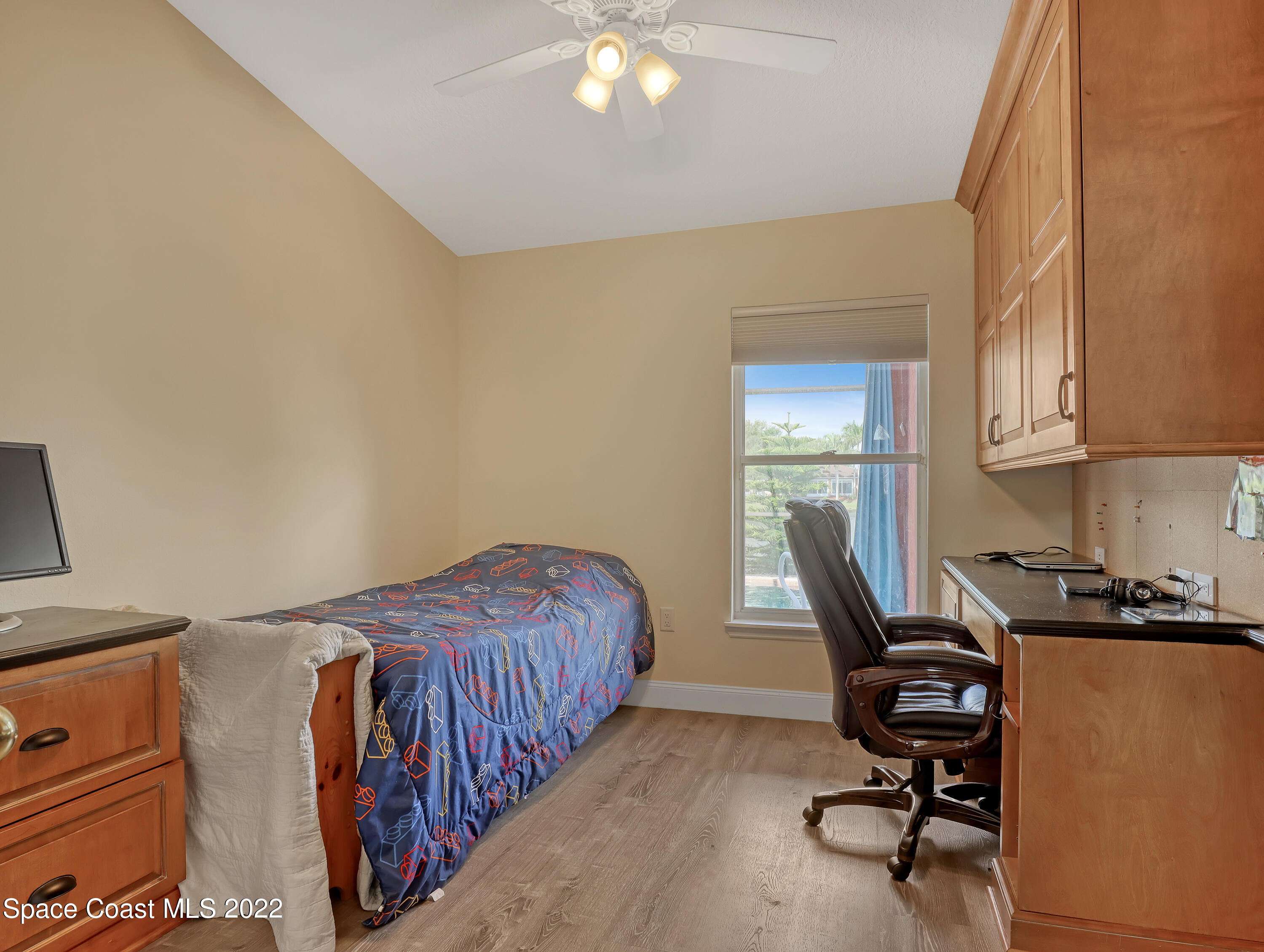3935 Orion Way Rockledge, FL 32955 - Photo 23 of 30 a bedroom with a bed and a chandelier