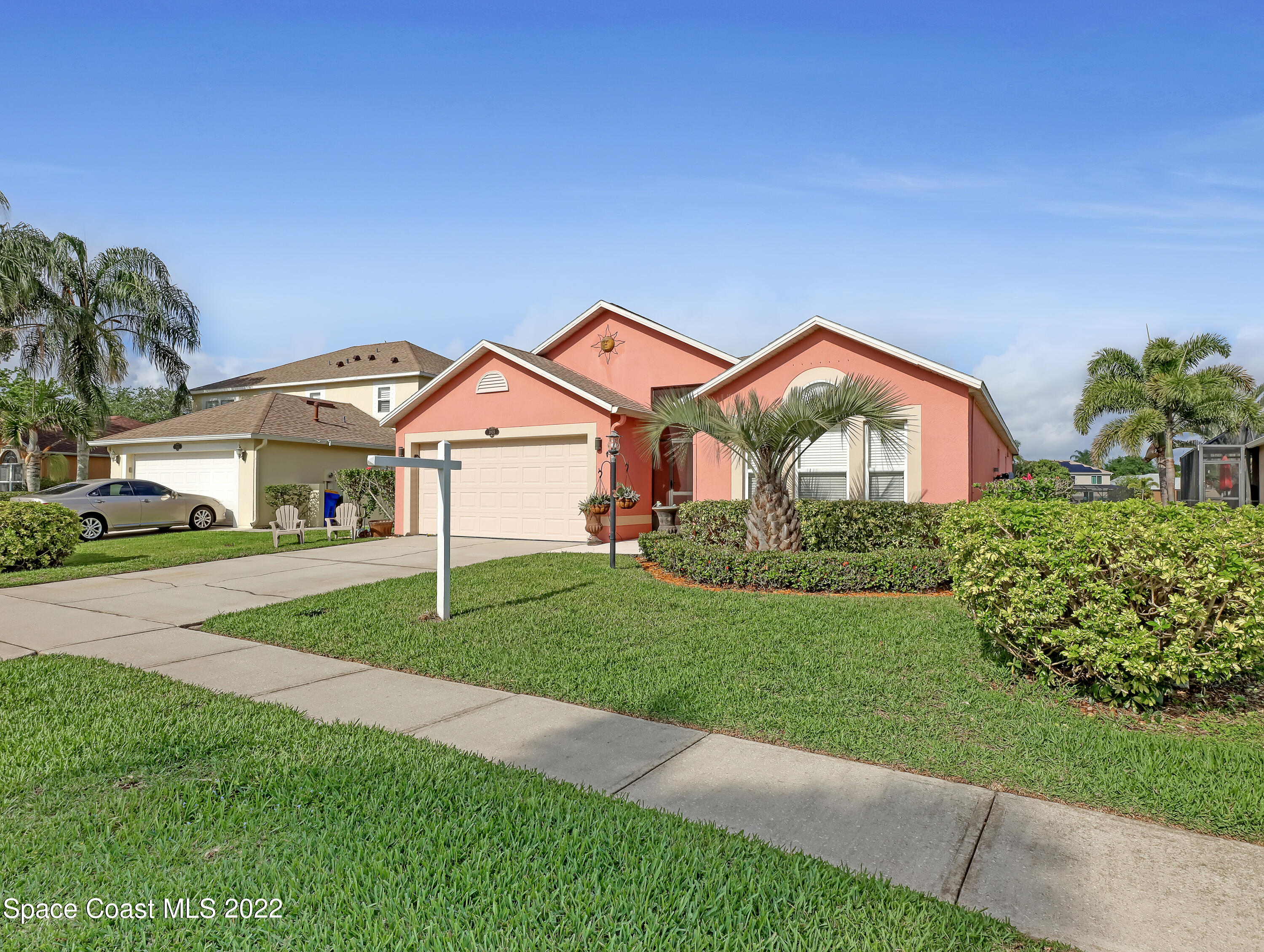 3935 Orion Way Rockledge, FL 32955 - Photo 3 of 30 a front view of a house with a yard and garage