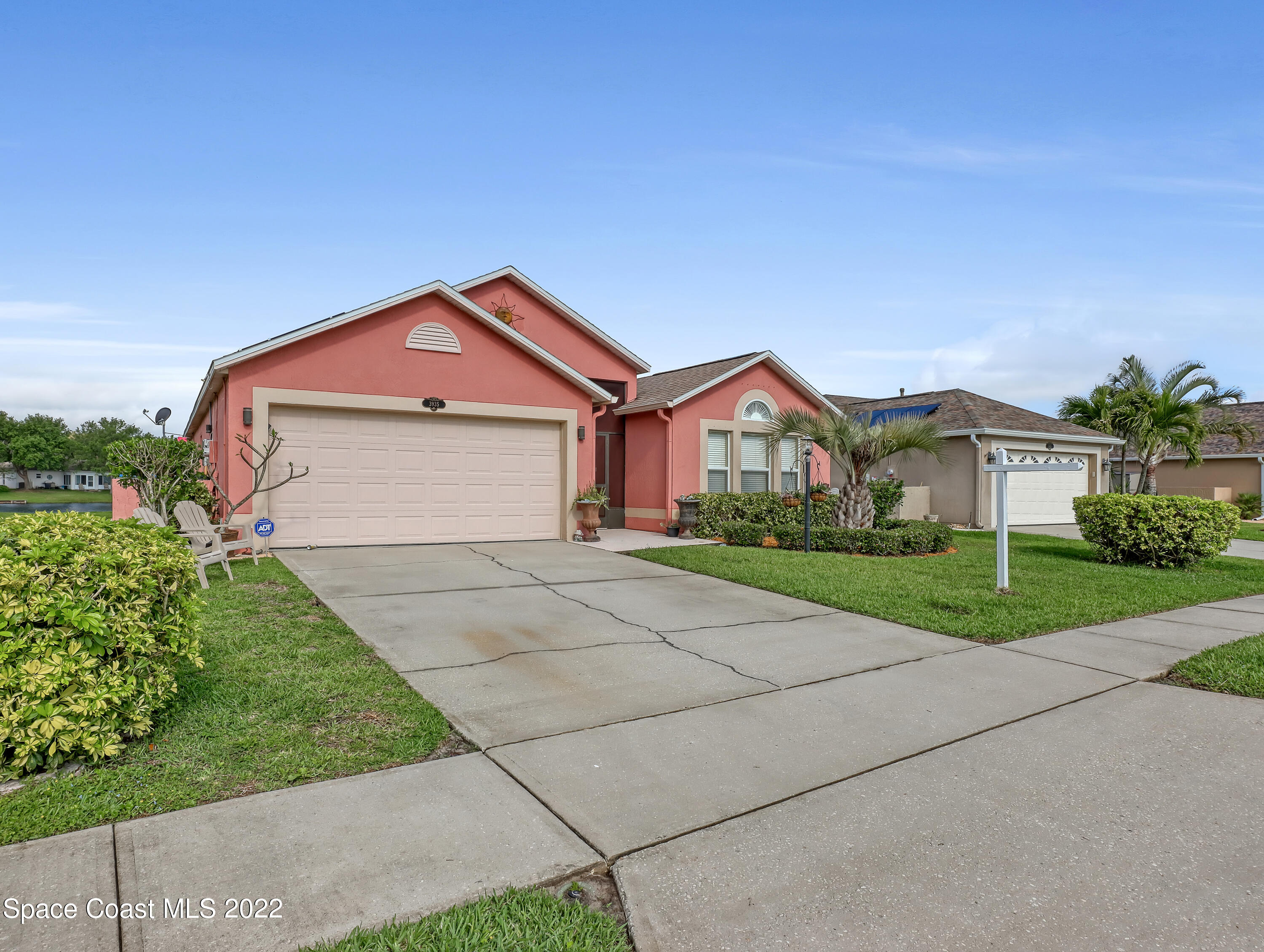 3935 Orion Way Rockledge, FL 32955 - Photo 4 of 30 a front view of a house with a yard and garage