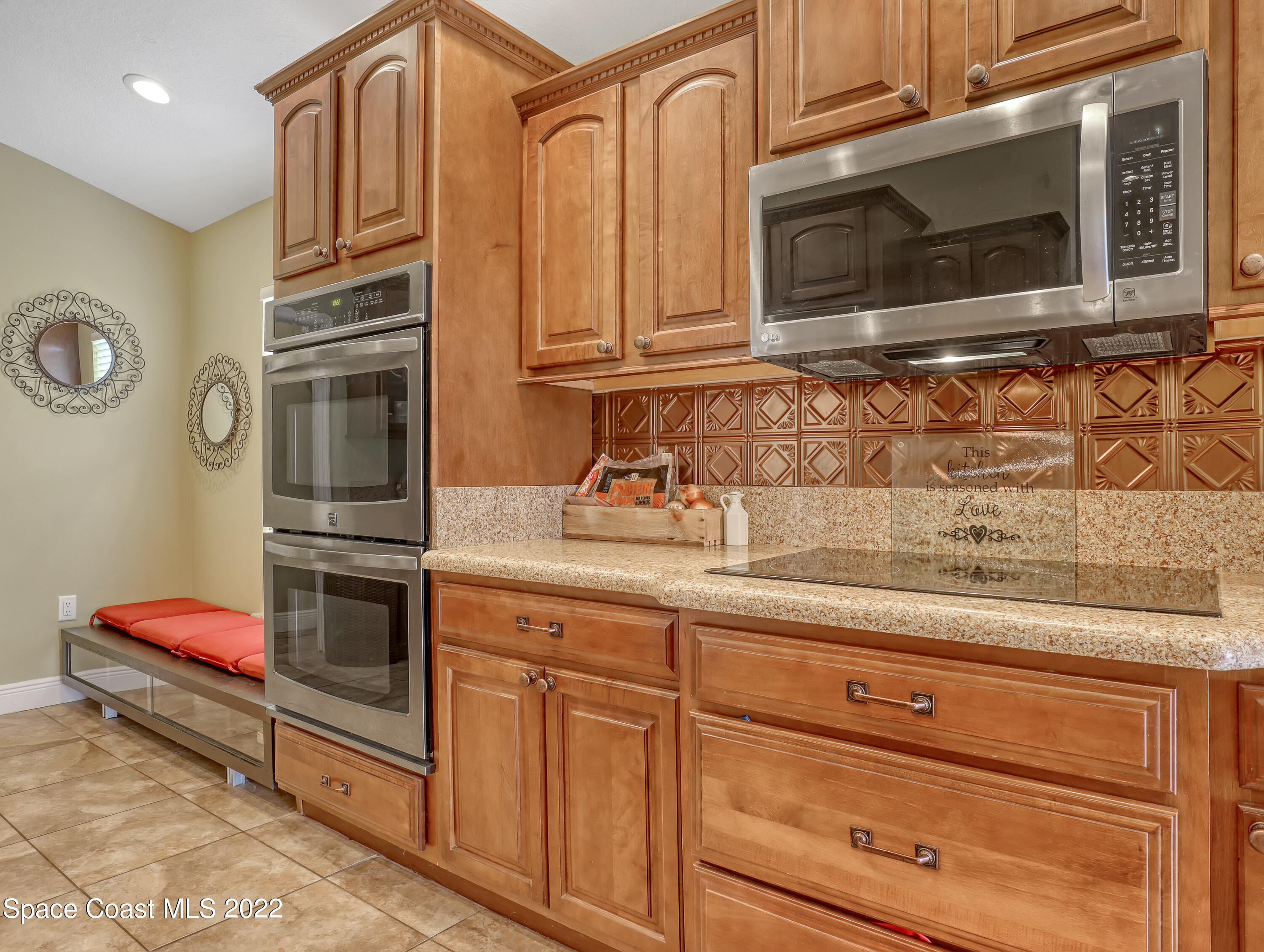 3935 Orion Way Rockledge, FL 32955 - Photo 8 of 30 a kitchen with granite countertop cabinets stainless steel appliances and wooden cabinets