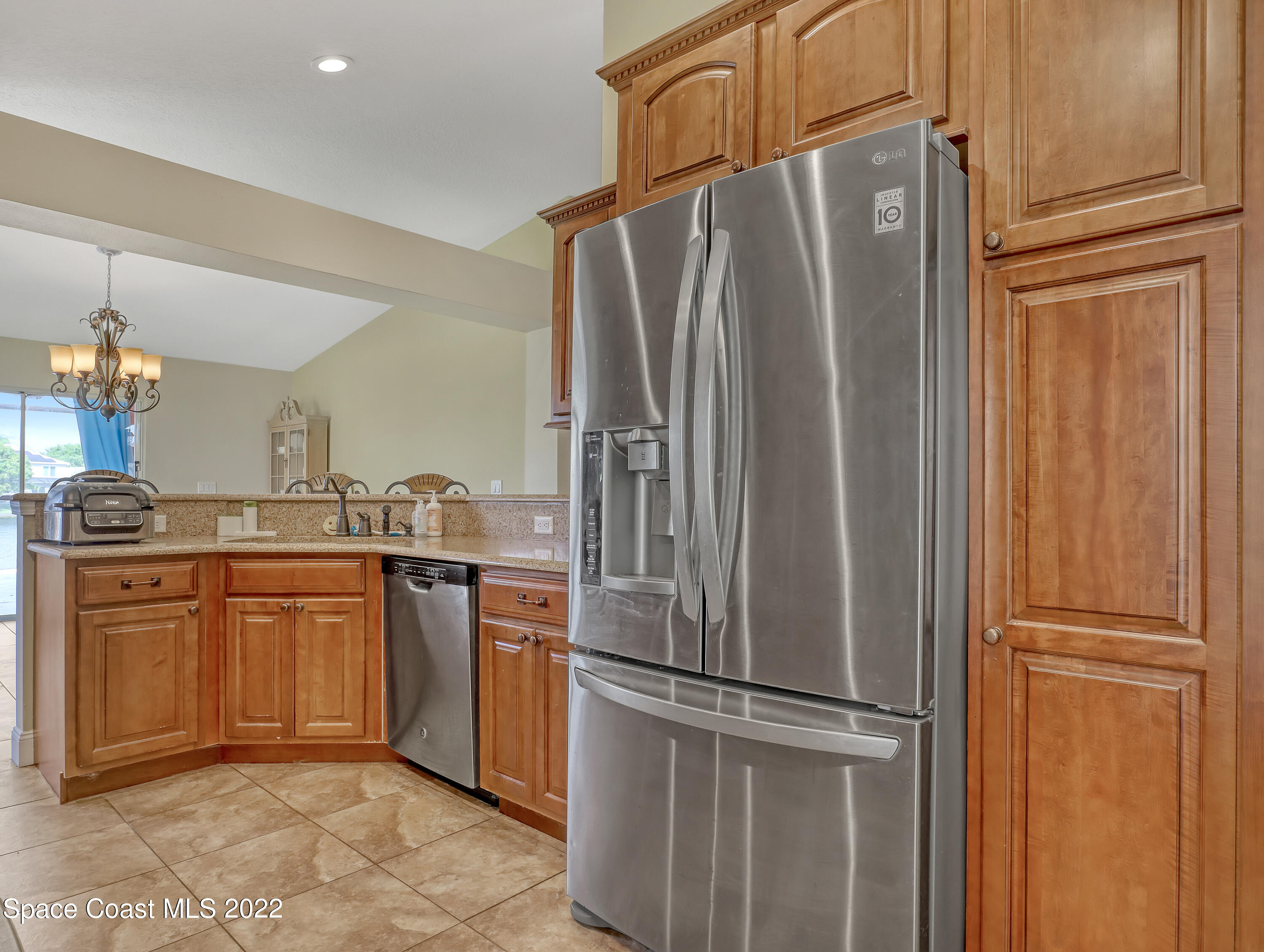 3935 Orion Way Rockledge, FL 32955 - Photo 9 of 30 a kitchen with stainless steel appliances granite countertop a refrigerator and a sink