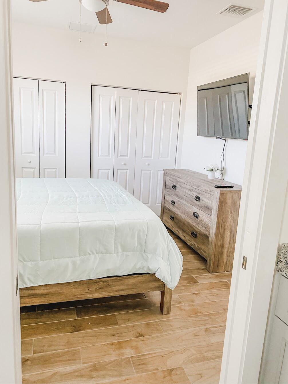 103 Osprey Circle Hypoluxo, FL 33462 - Photo 11 of 27 a bedroom with a bed and a window