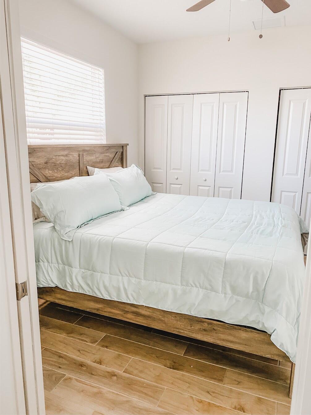 103 Osprey Circle Hypoluxo, FL 33462 - Photo 15 of 27 a bedroom with a bed and a window