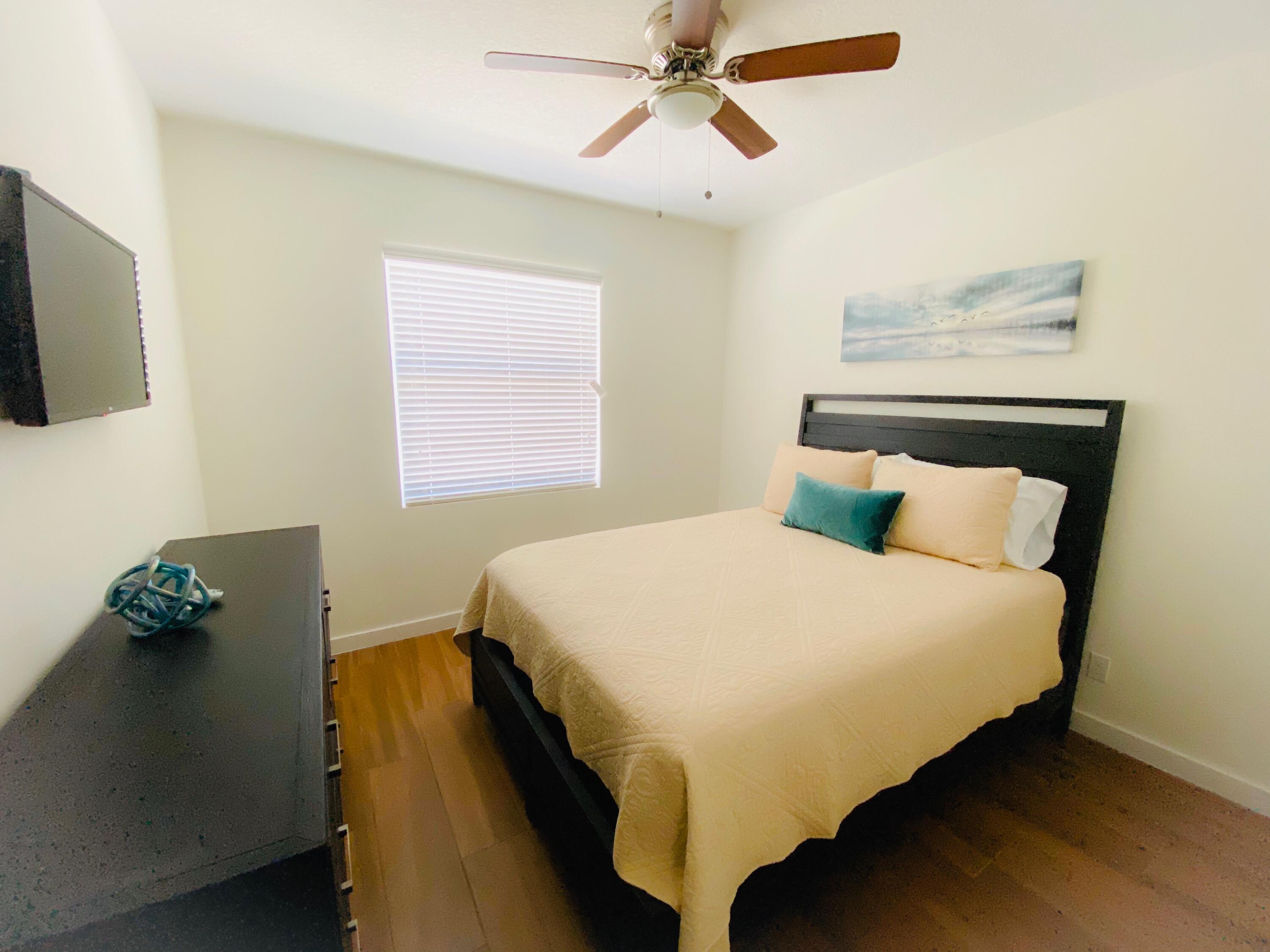 103 Osprey Circle Hypoluxo, FL 33462 - Photo 18 of 27 a bedroom with a bed and a window