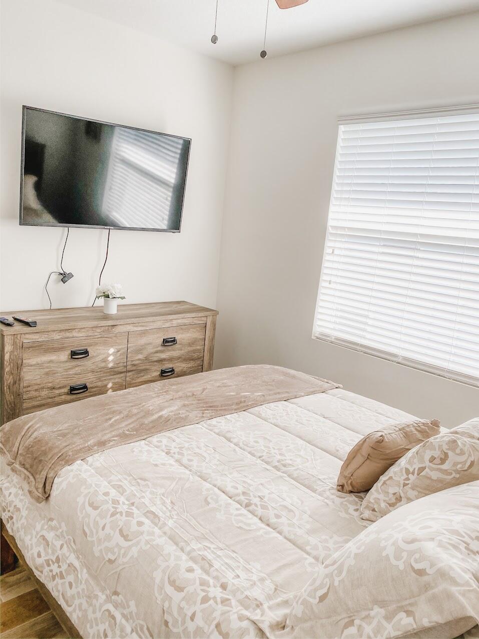 103 Osprey Circle Hypoluxo, FL 33462 - Photo 20 of 27 a bedroom with a bed and a flat screen tv