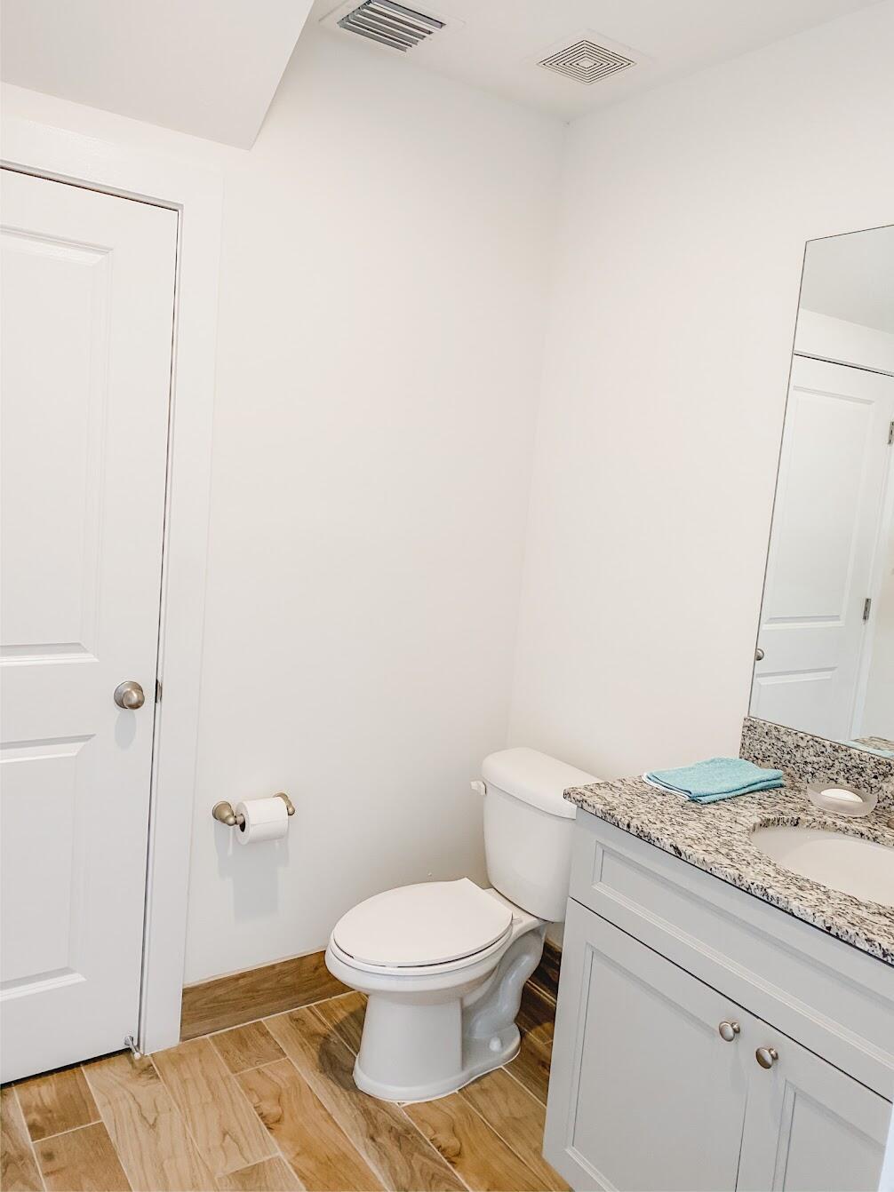 103 Osprey Circle Hypoluxo, FL 33462 - Photo 21 of 27 a bathroom with a granite countertop toilet and a sink