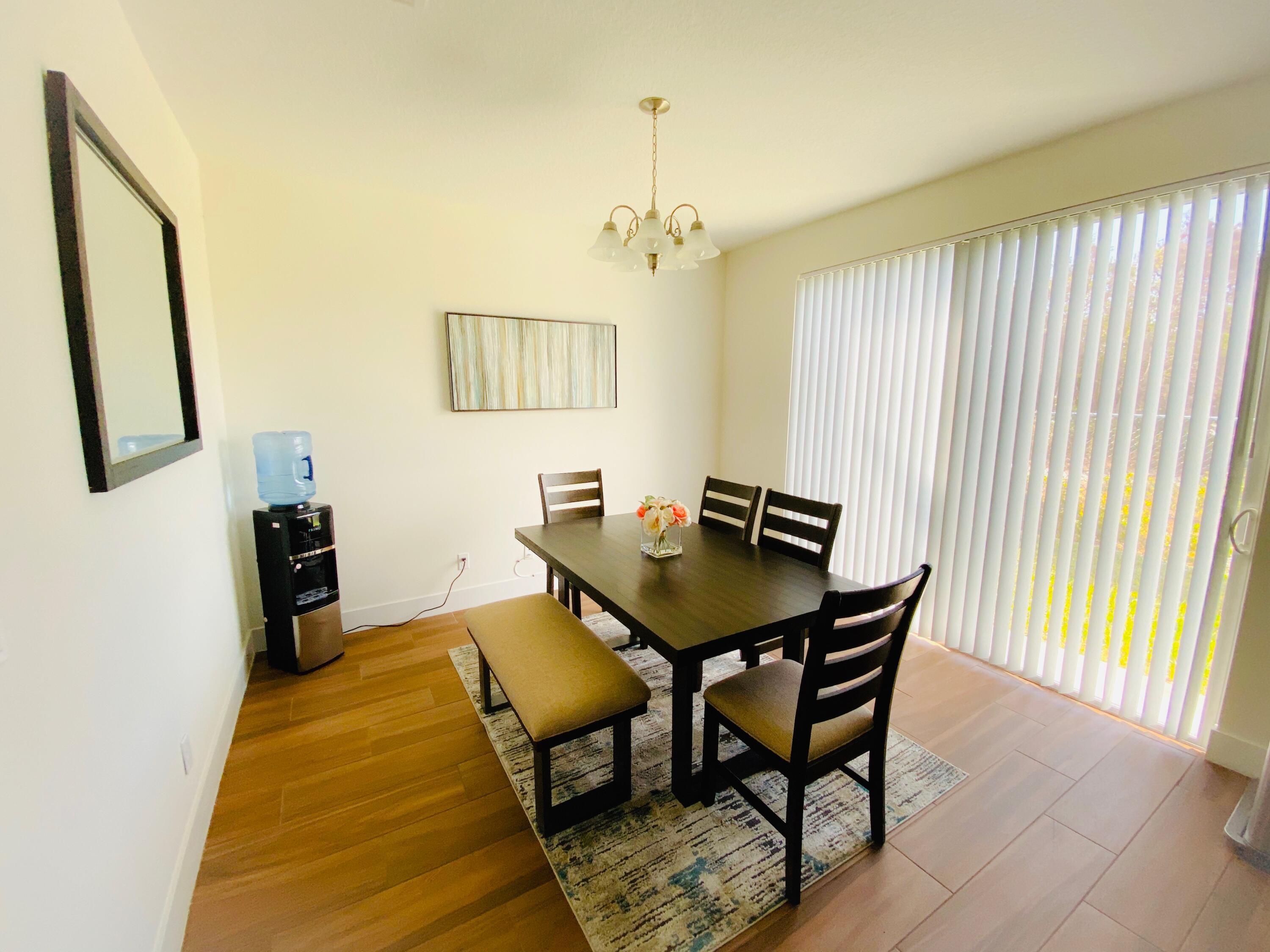 103 Osprey Circle Hypoluxo, FL 33462 - Photo 22 of 27 a view of a dining room with furniture and a window