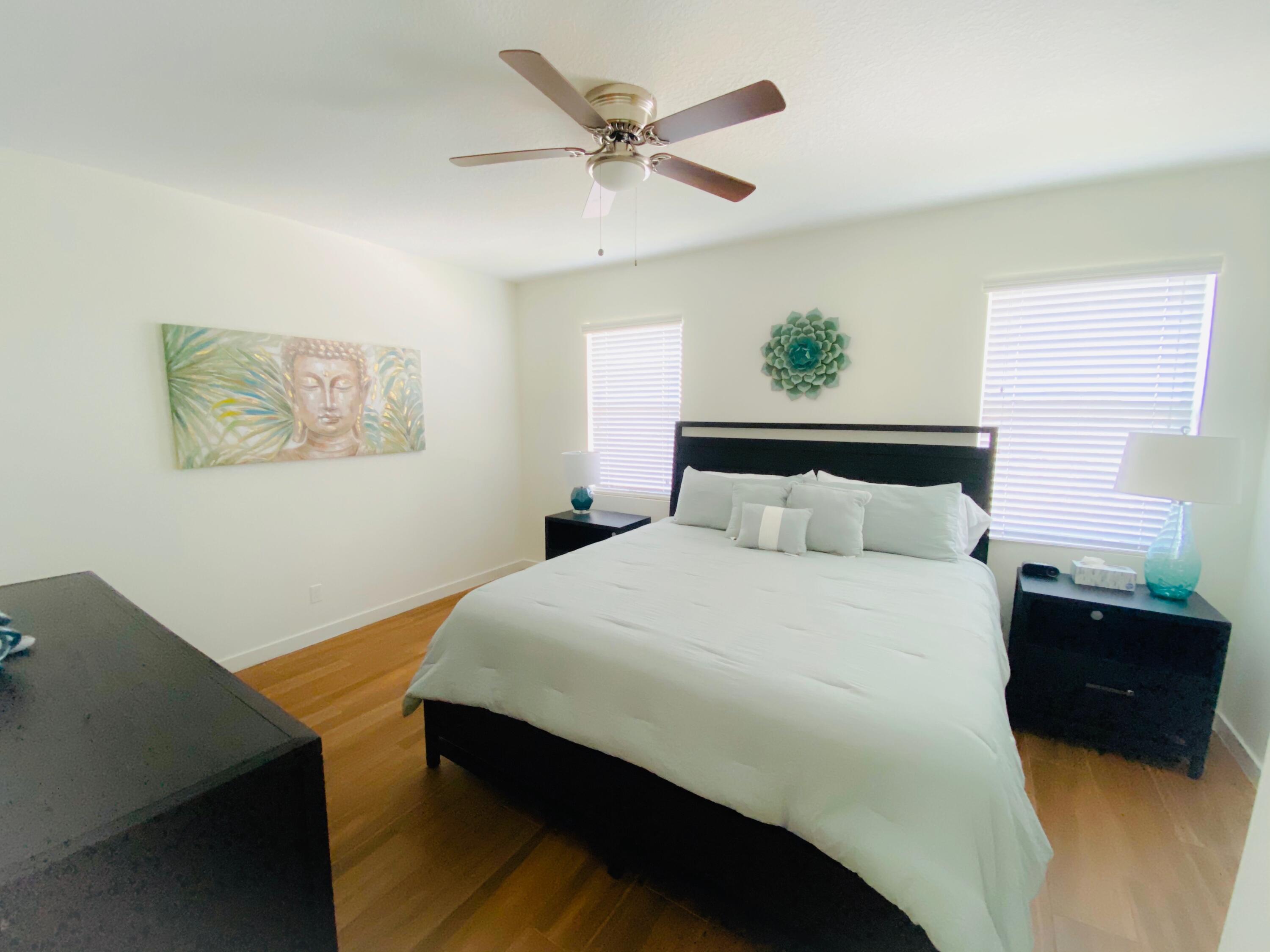 103 Osprey Circle Hypoluxo, FL 33462 - Photo 23 of 27 a bedroom with a bed and a window