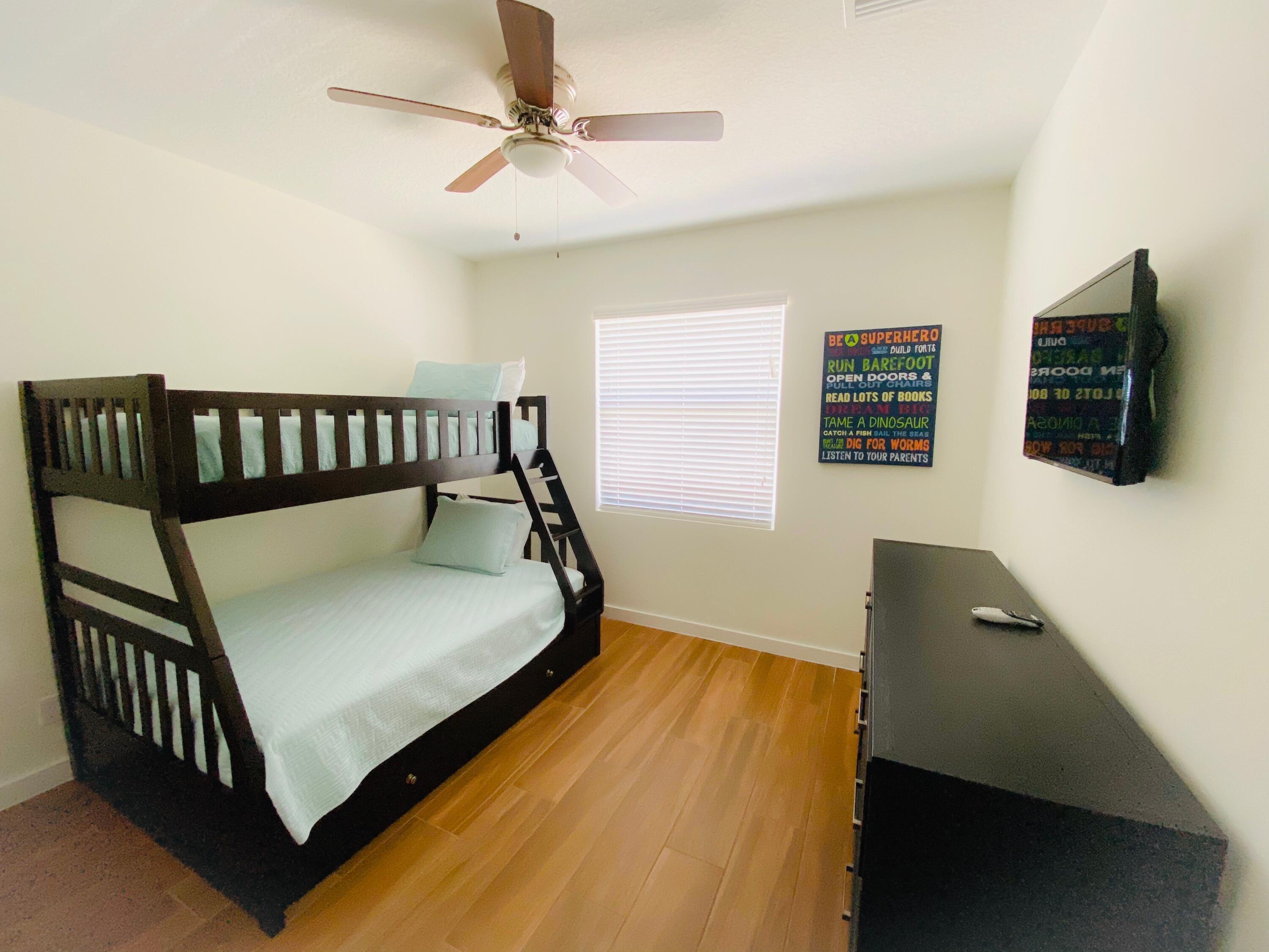 103 Osprey Circle Hypoluxo, FL 33462 - Photo 27 of 27 a bed sitting in a bedroom next to a window