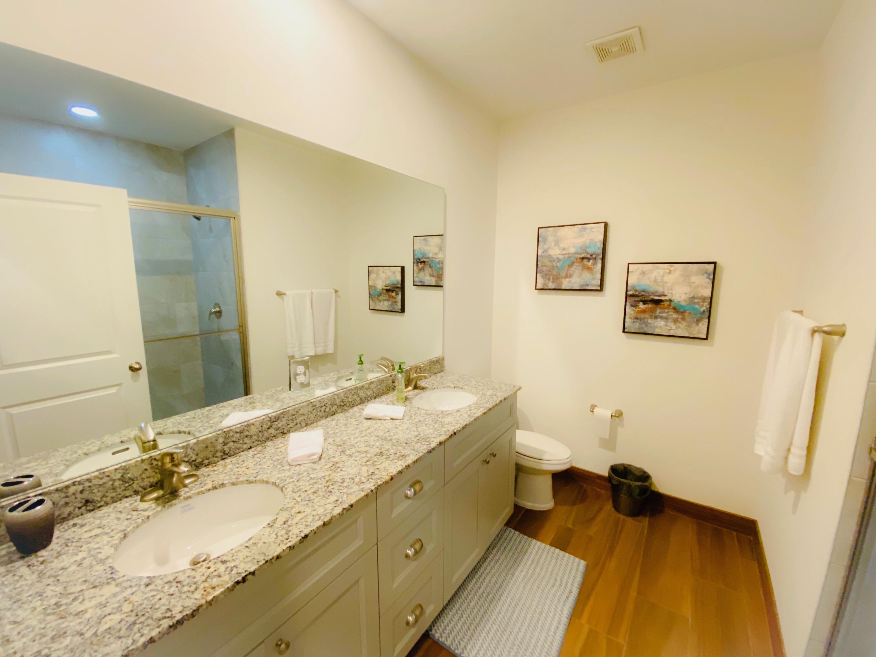 103 Osprey Circle Hypoluxo, FL 33462 - Photo 5 of 27 a bathroom with a granite countertop sink mirror vanity and toilet