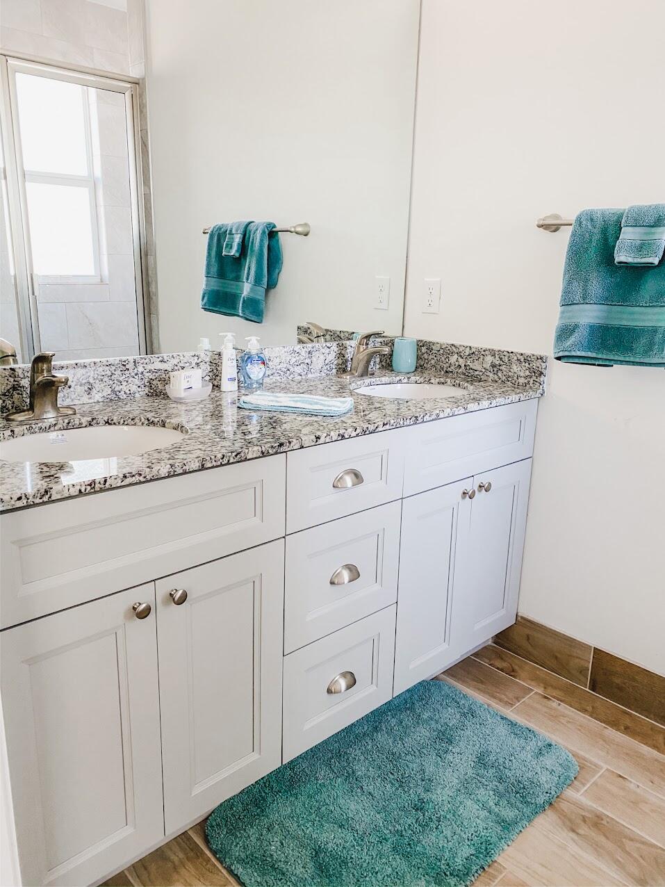 103 Osprey Circle Hypoluxo, FL 33462 - Photo 7 of 27 a bathroom with a granite countertop sink and a mirror