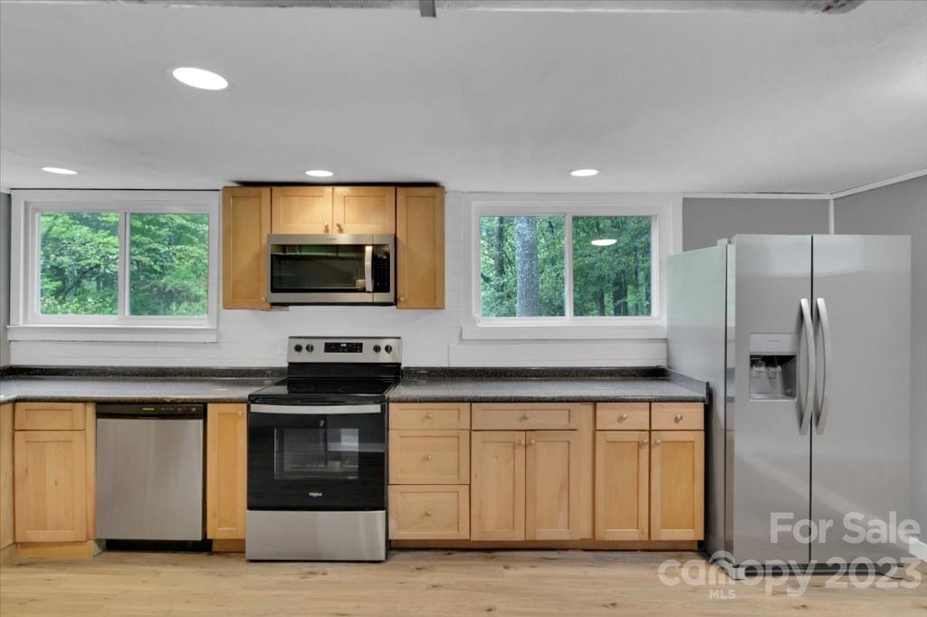 62 Kinard Lane Penrose, NC 28766 - Photo 19 of 25 a kitchen with stainless steel appliances granite countertop a stove a refrigerator and a microwave