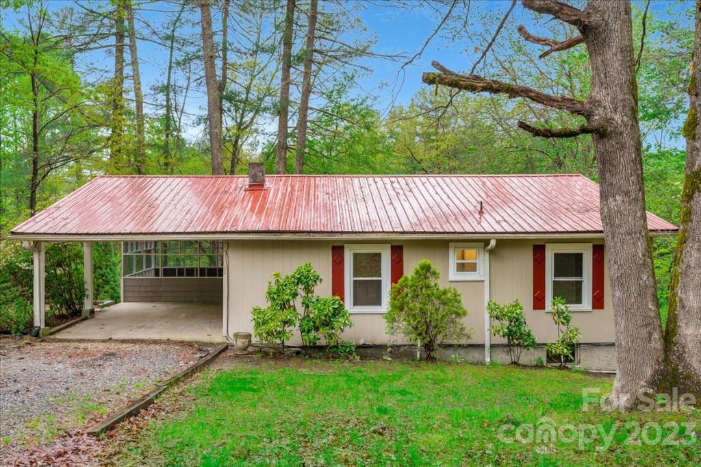 62 Kinard Lane Penrose, NC 28766 - Photo 2 of 25 a backyard of a house with plants and large tree