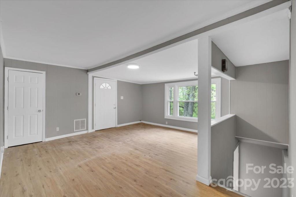 62 Kinard Lane Penrose, NC 28766 - Photo 9 of 25 a view of an empty room with wooden floor and a window