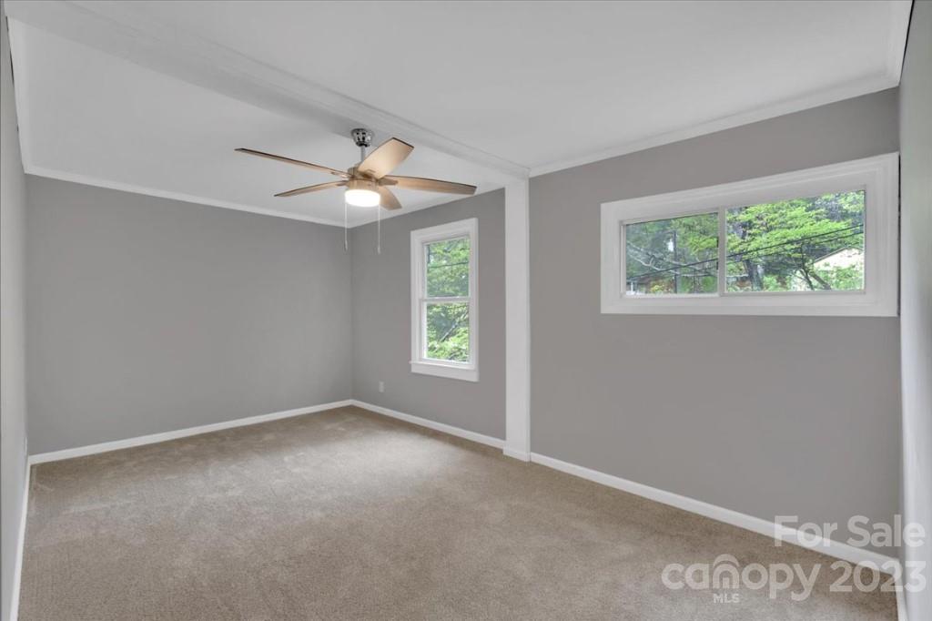 62 Kinard Lane Penrose, NC 28766 - Photo 10 of 25 an empty room with a window and a fan