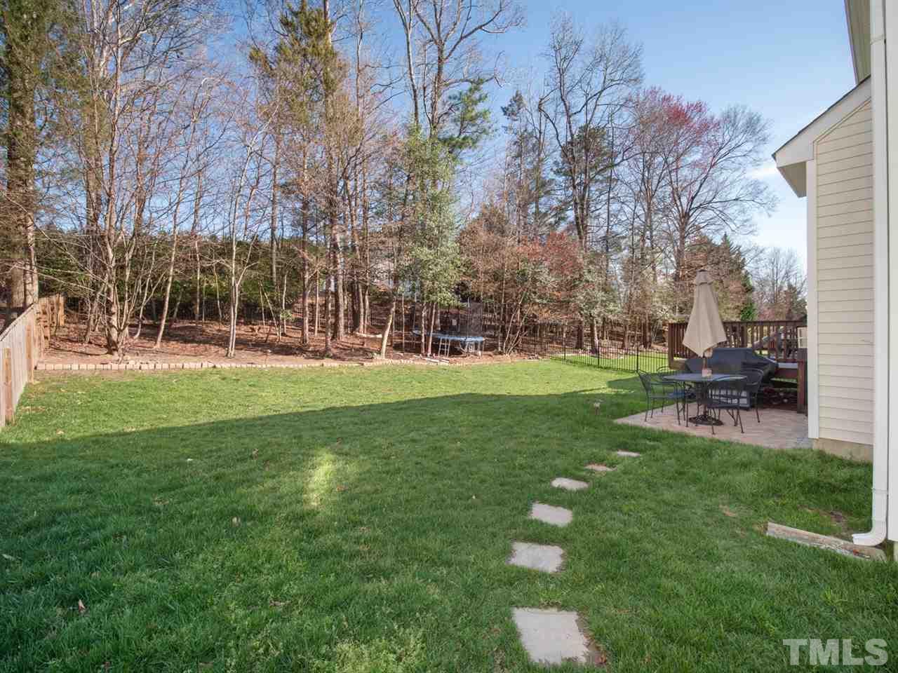 2221 Spruce Shadows Lane Raleigh, NC 27614 - Photo 2 of 27 Year round green grass in this large, flat backyard, backed by privacy trees.