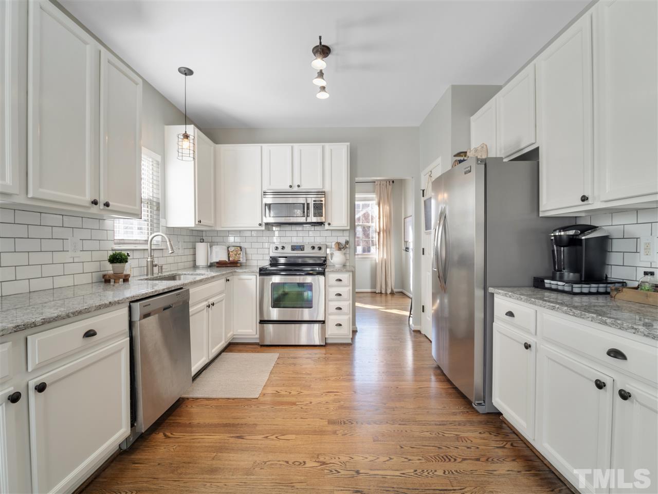 2221 Spruce Shadows Lane Raleigh, NC 27614 - Photo 4 of 27 Just finished the last of the kitchen remodel in 2019. Over the past year, sellers have updated lighting, backsplash, granite counters and white cabinetry.