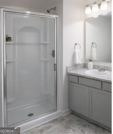 a bathroom with a granite countertop sink mirror and shower
