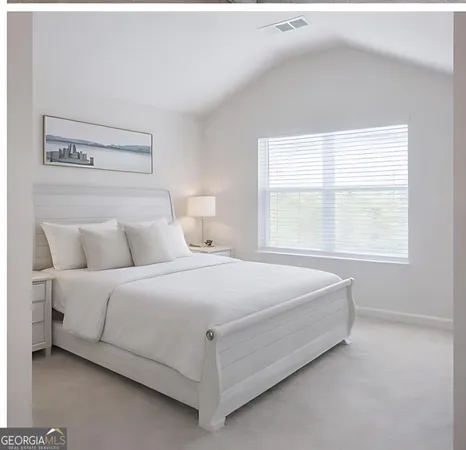 a bedroom with a bed and window