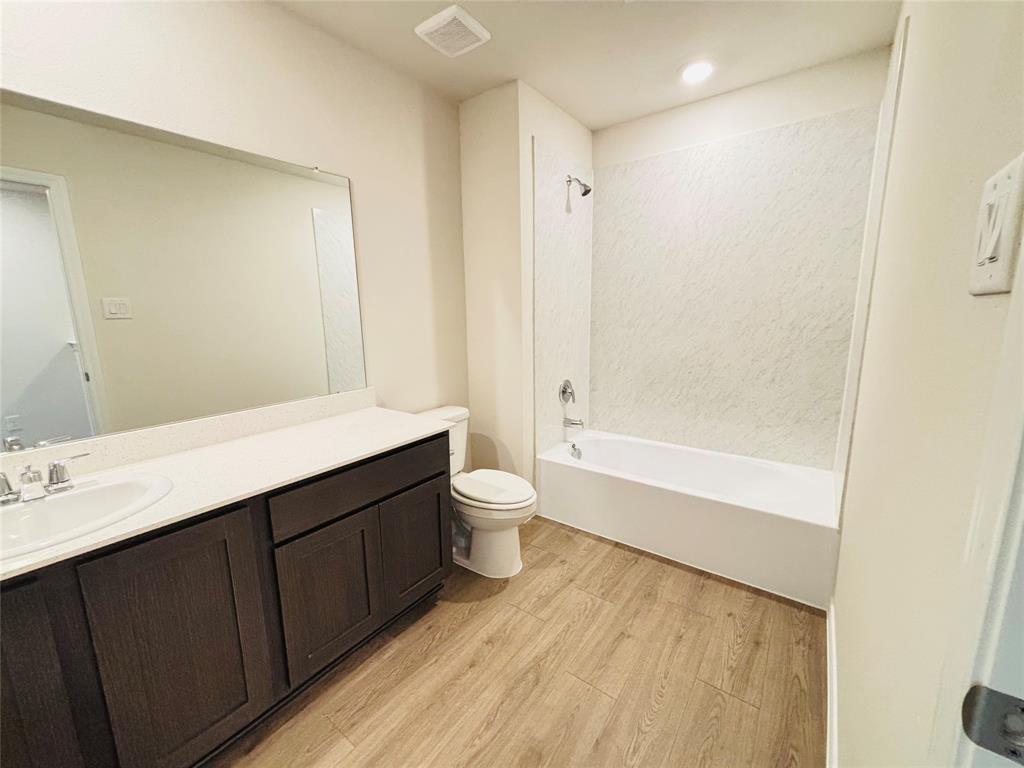 120 Redwood Road Princeton, TX 75407 - Photo 20 of 24 Full bathroom featuring a single vanity with wood-finish cabinetry, a white countertop, and an integrated sink