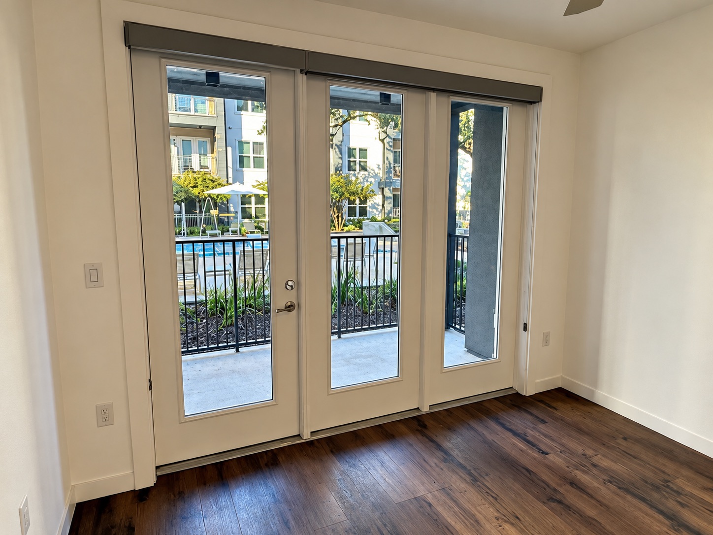 4801 Springdale Road, Unit 1106 Austin, TX 78723 - Photo 15 of 22 French doors open directly to a private balcony overlooking the community pool.