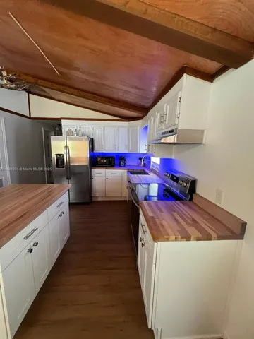 a kitchen with stainless steel appliances granite countertop a sink counter space and cabinets