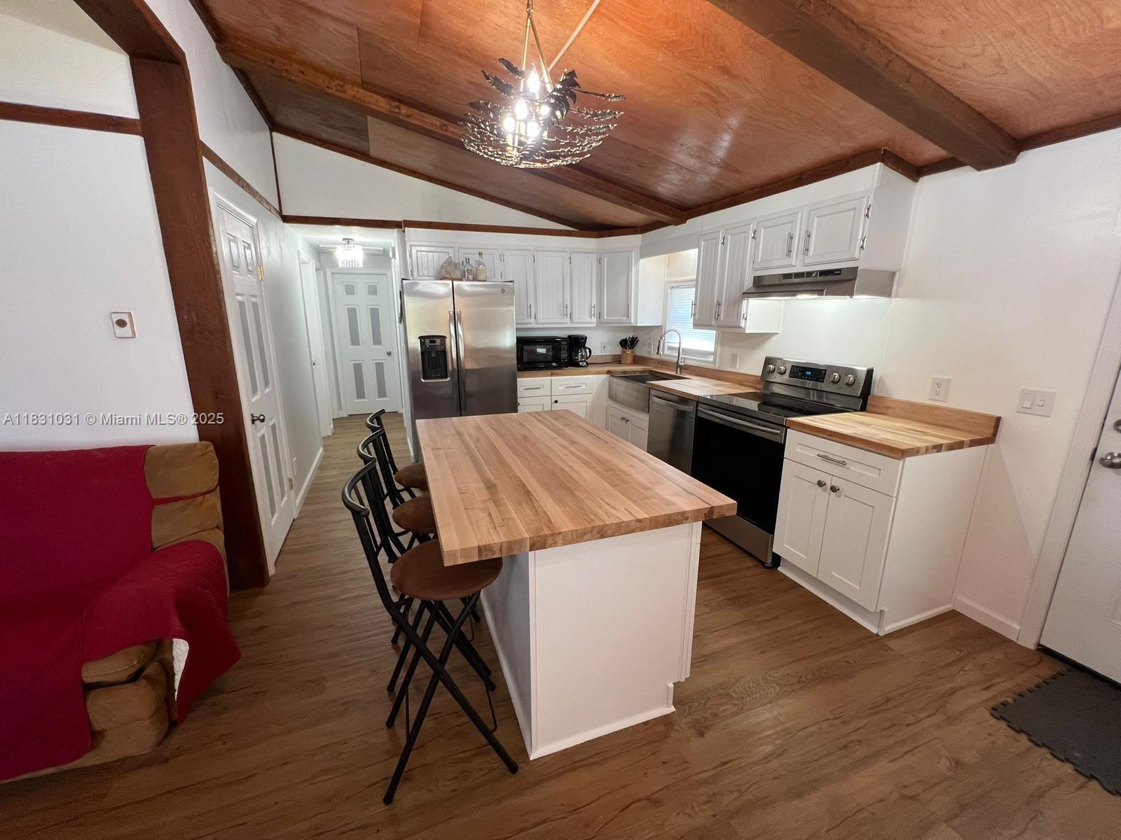 123 Rocky Road Lackawaxen, PA 18435 - Photo 15 of 39 a kitchen that has a lot of cabinets a sink a stove and wooden floor