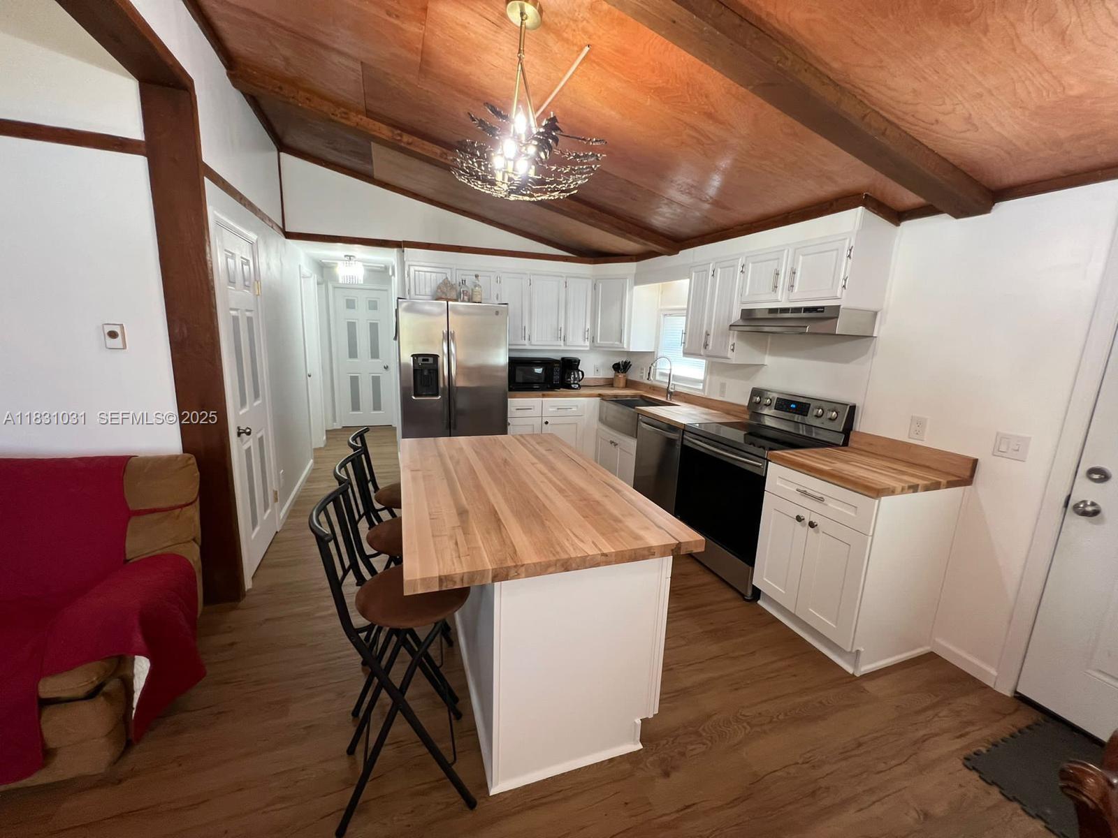 123 Rocky Road Lackawaxen, PA 18435 - Photo 16 of 39 a kitchen with a table chairs refrigerator and cabinets
