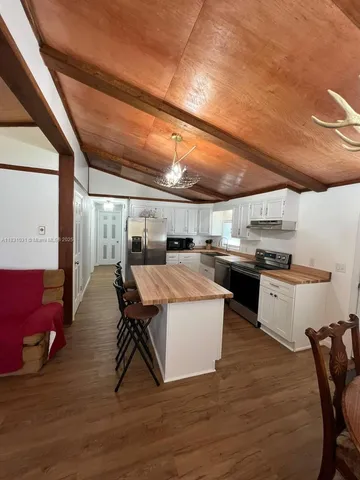 a kitchen with a sink a counter top space and stainless steel appliances
