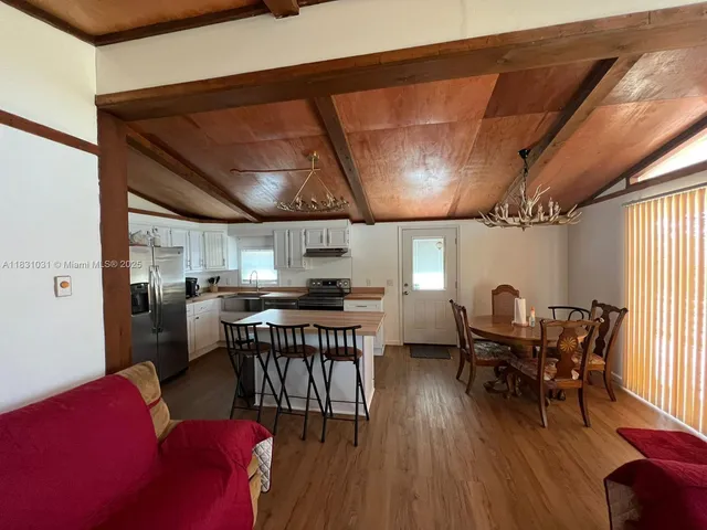a kitchen with stainless steel appliances granite countertop a stove refrigerator and cabinets