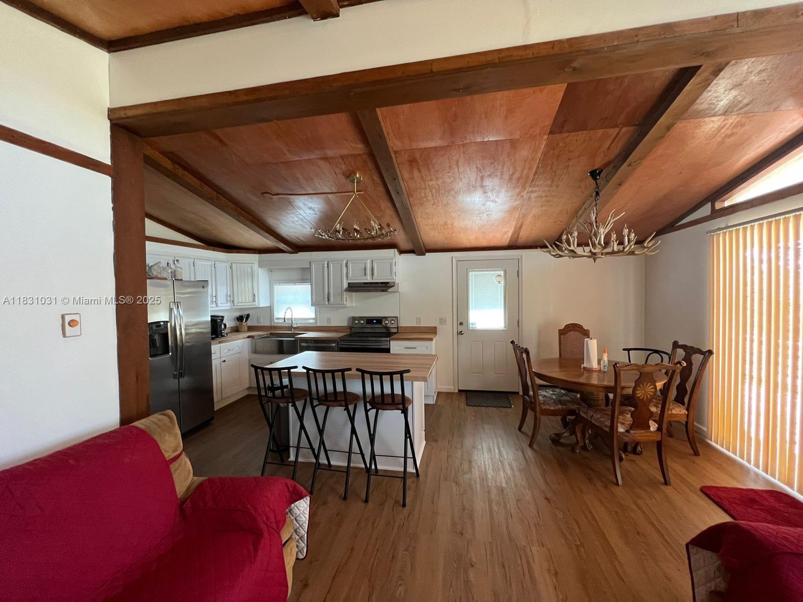 123 Rocky Road Lackawaxen, PA 18435 - Photo 24 of 39 a dining room with furniture a rug and a chandelier